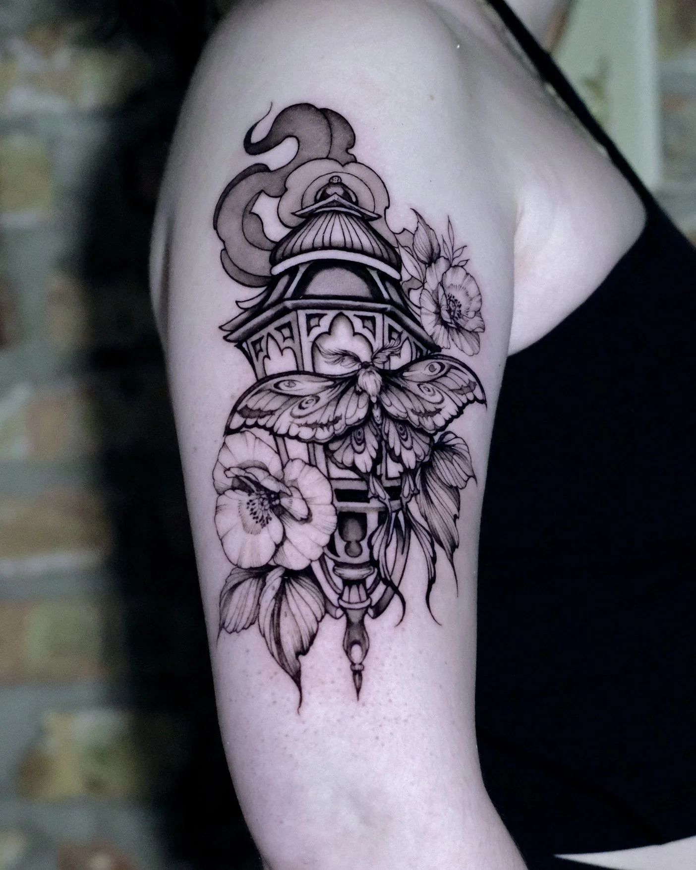 black work ornamental lantern tattoo with smoke and with florals. peonies and poppies. 