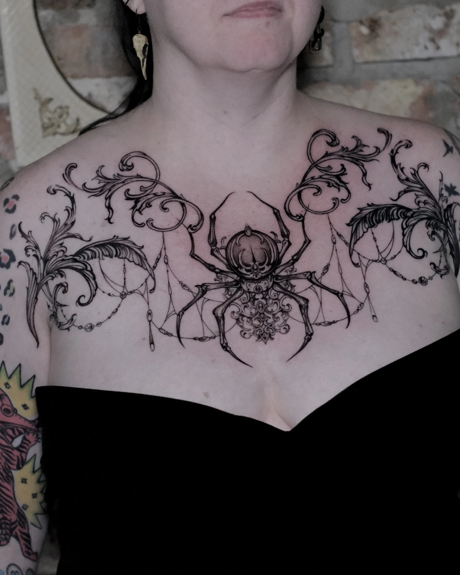 jewel spider chest tattoo. Very feminine with hanging down jewels and spiderwebs. gothic victorian baroque tattoo design 