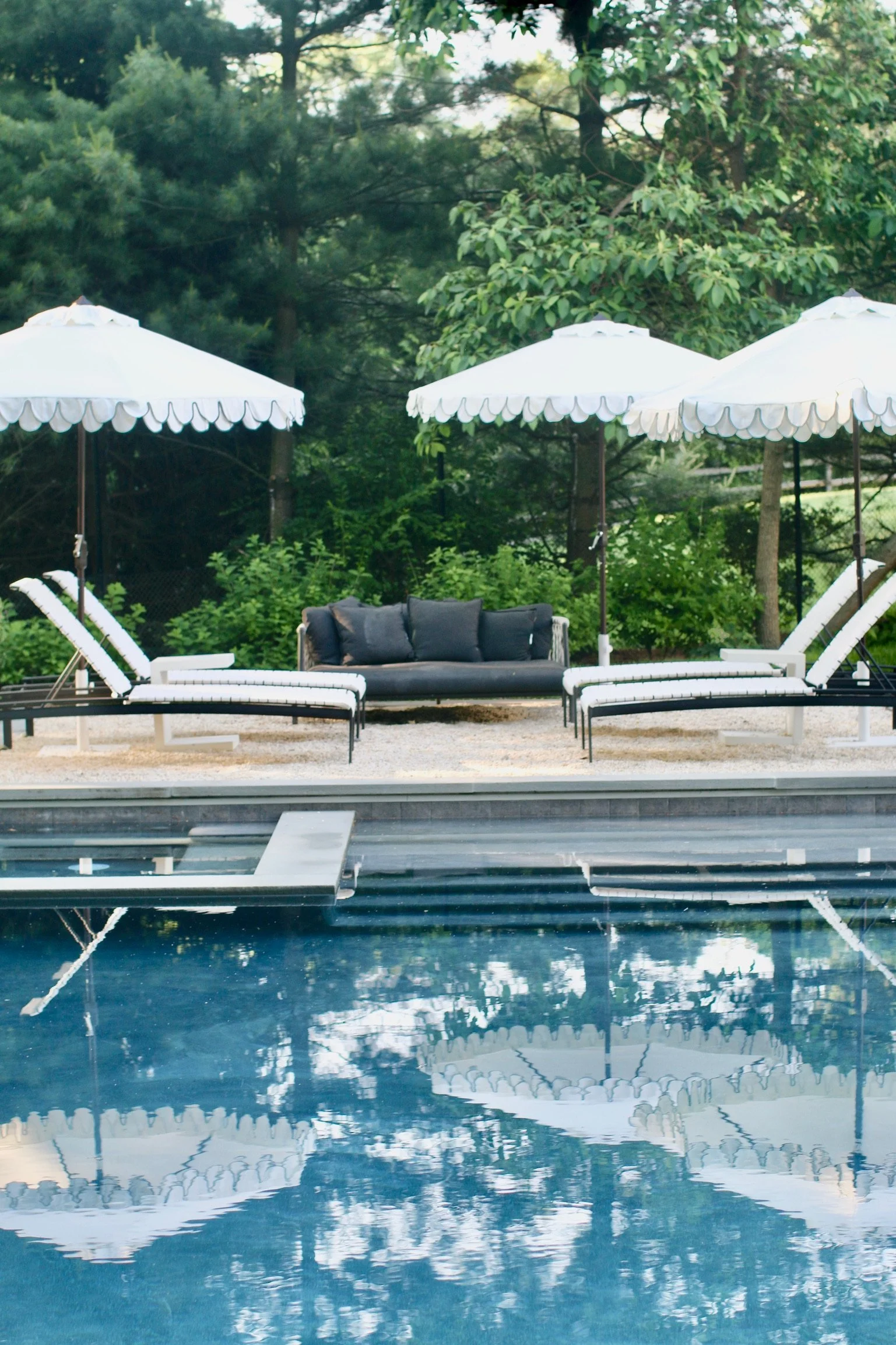 Scalloped umbrellas reflected in the pool