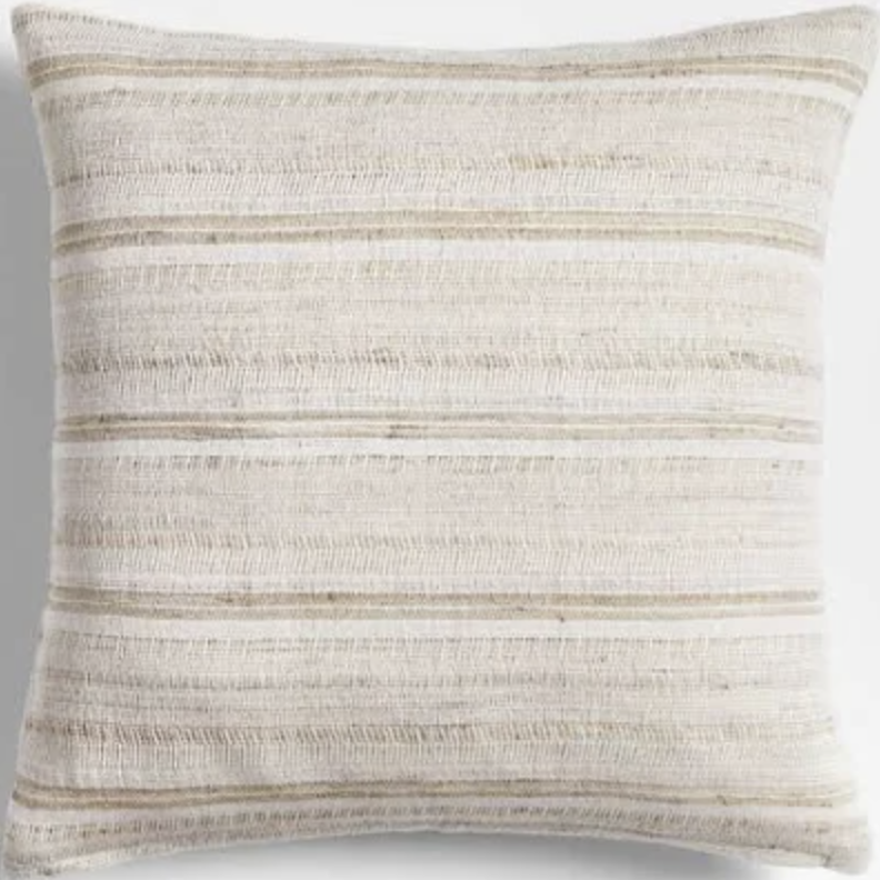 Close-up of a beige and cream striped decorative throw pillow on a white background.