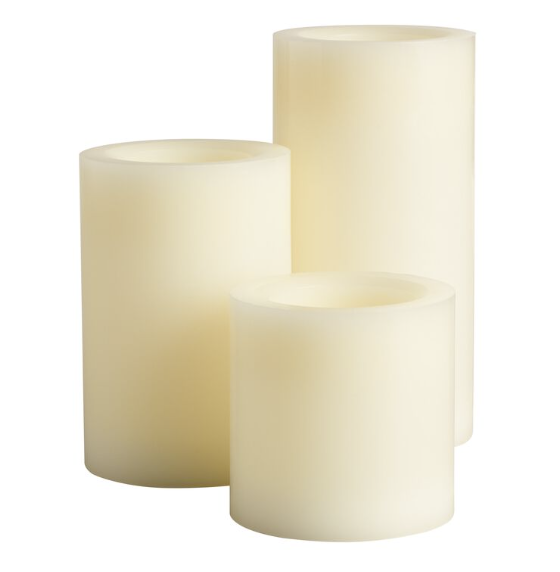 Three LED flameless candles of varying heights with a cream color and smooth surface