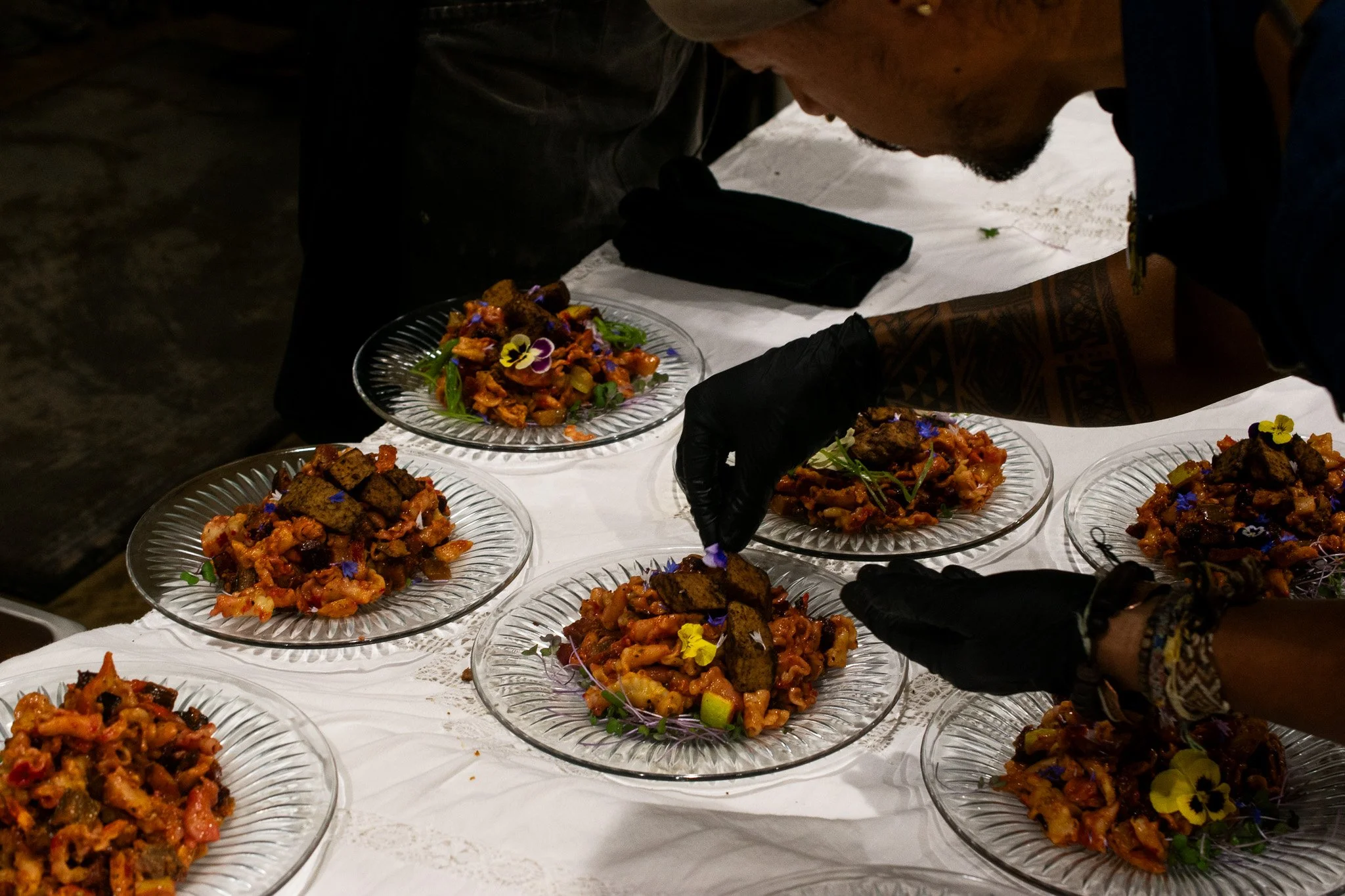 Chef Juan putting final touches on his delicious main course: pasta with epazote red sauce, roasted veggies, and homemade tempeh!