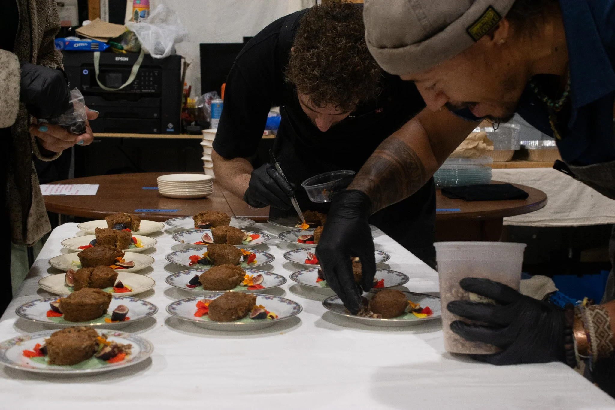 Chef Juan and team finish plating wonderful carrot cake cupcakes, served with edible flowers and a mint & thai basil coconut cream
