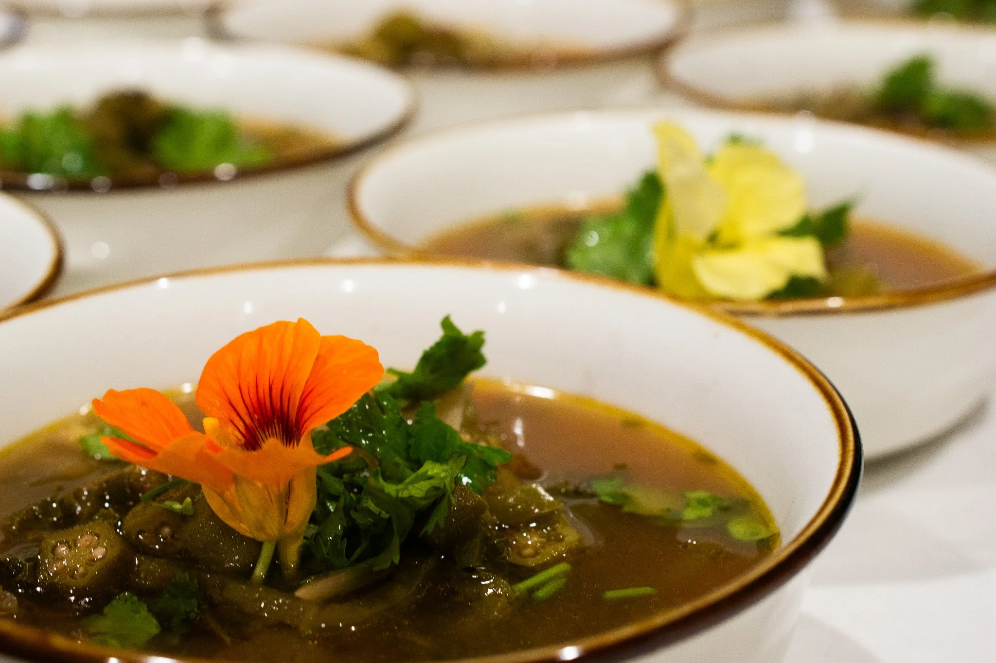 Chef Juan's beautiful okra stew, topped with nastirtium