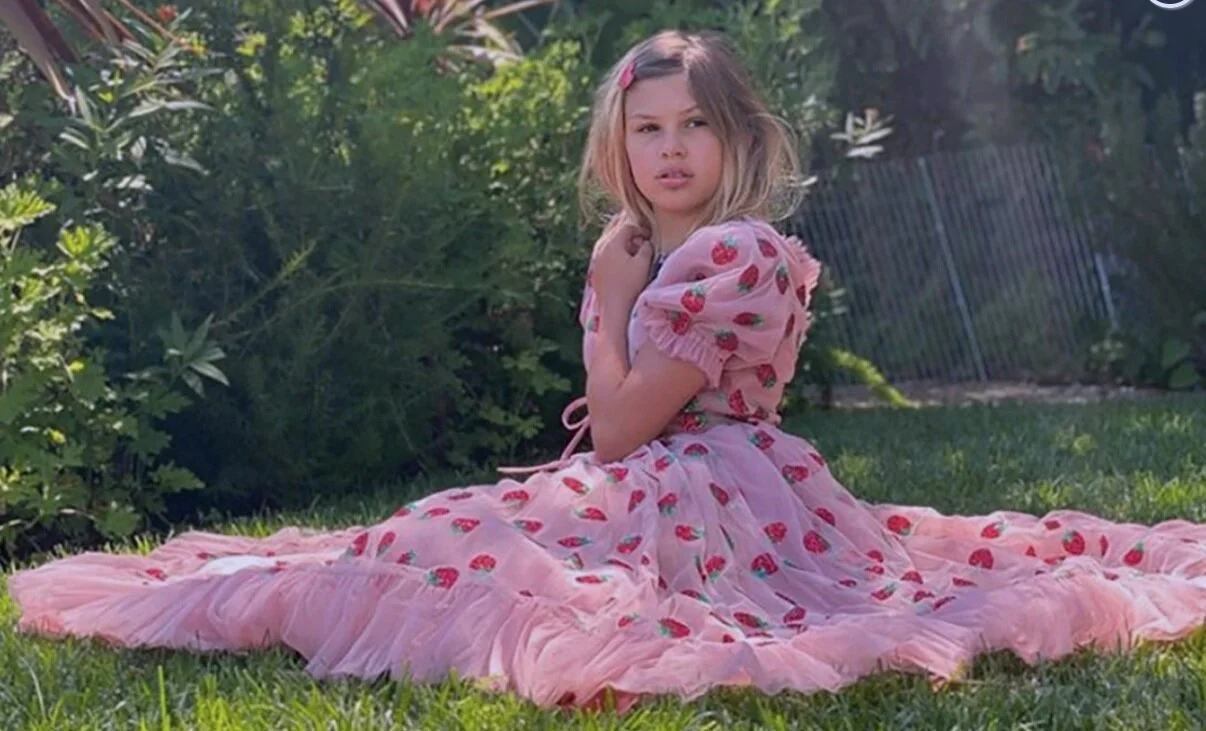 Made of lightweight tulle netting with a full skirt and ruffled puffed sleeves, the high-waist area of the dress is belted around with a thin tied-up string, creating a fun vintage look. (Busy Phillips)
