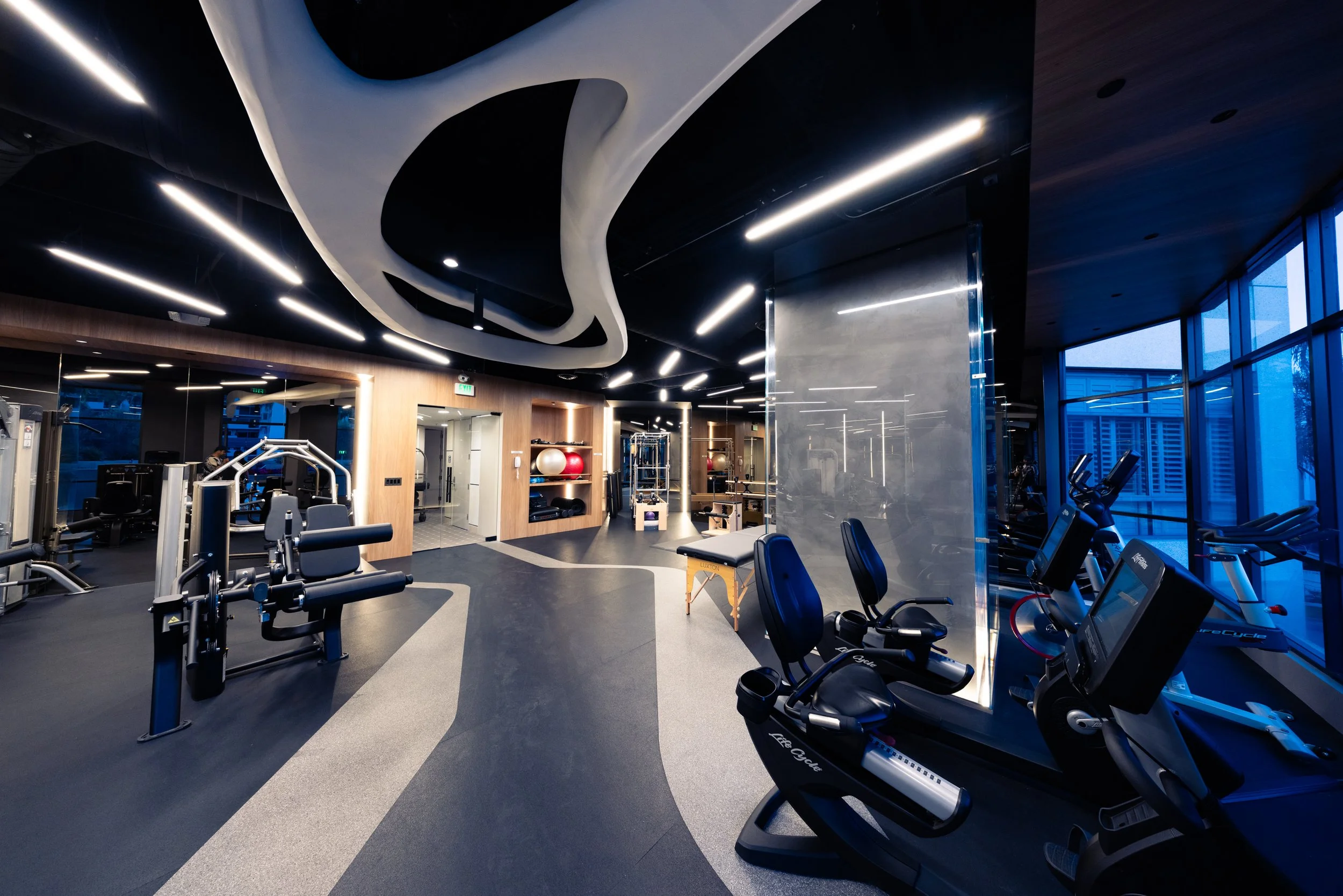 Inspiring ceiling sculpture and lighting design at a contemporary gym at a luxury condominium in Los Angeles, CA.