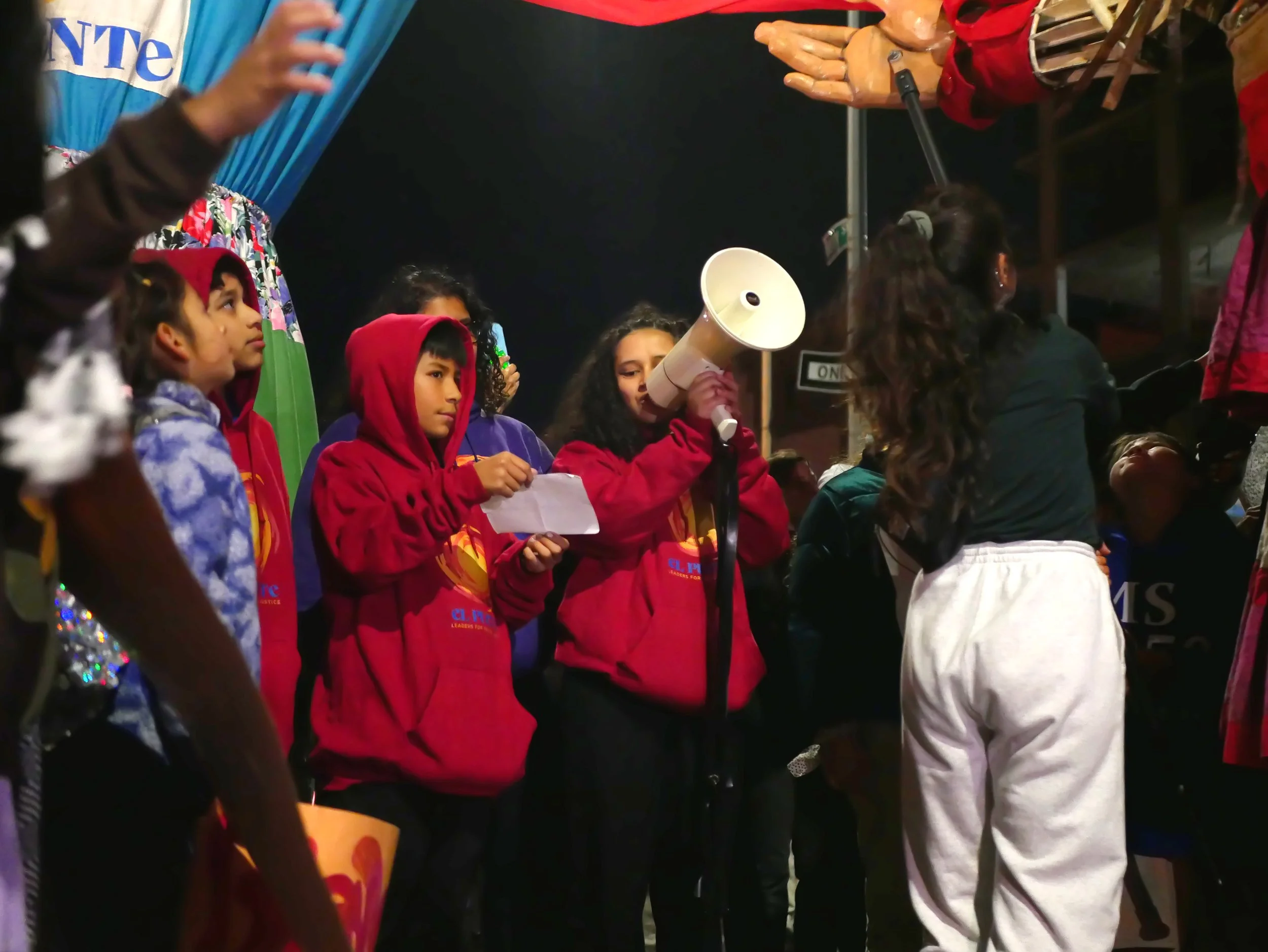 student reads to Amal through a bullhorn