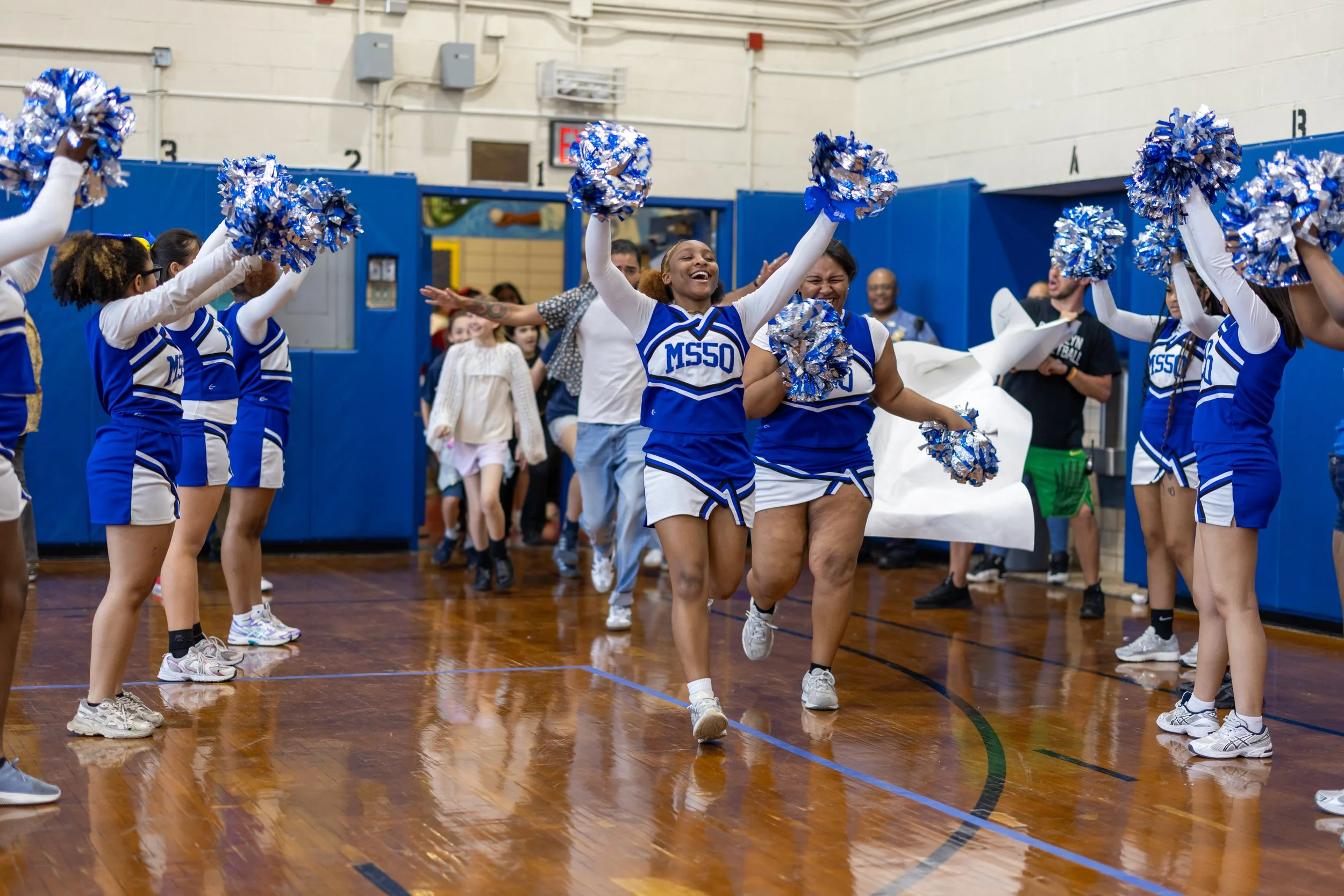 Students run through banners at pep rally