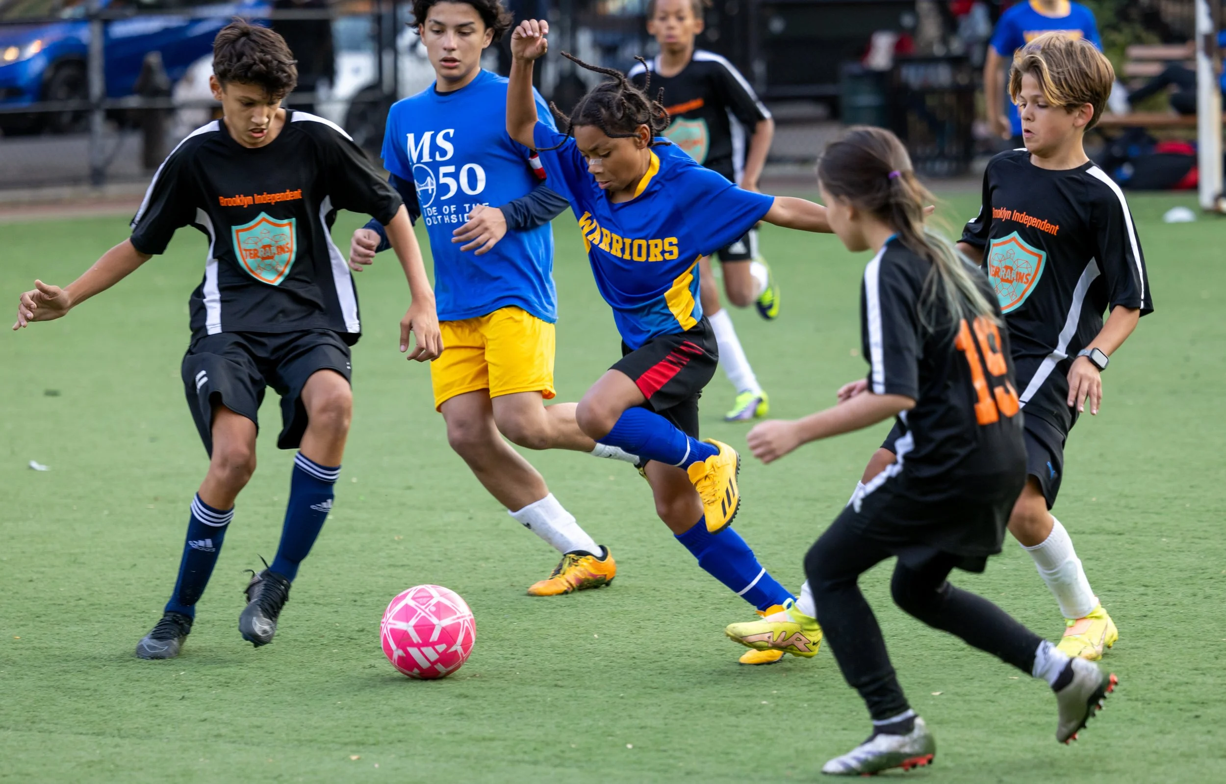 Students dribbles in a soccer match