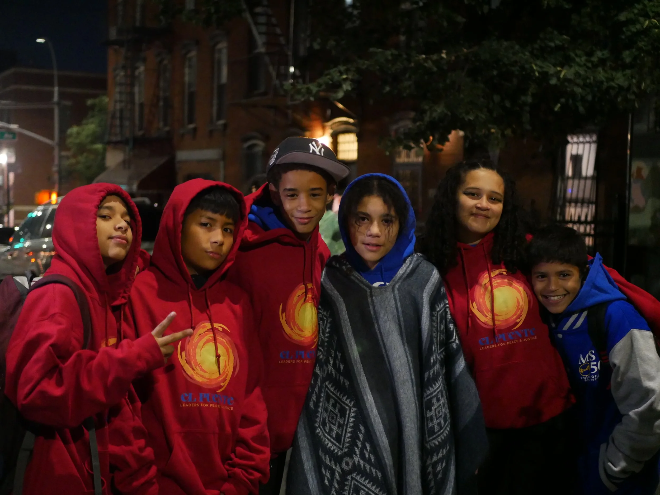 six students pose and smile together