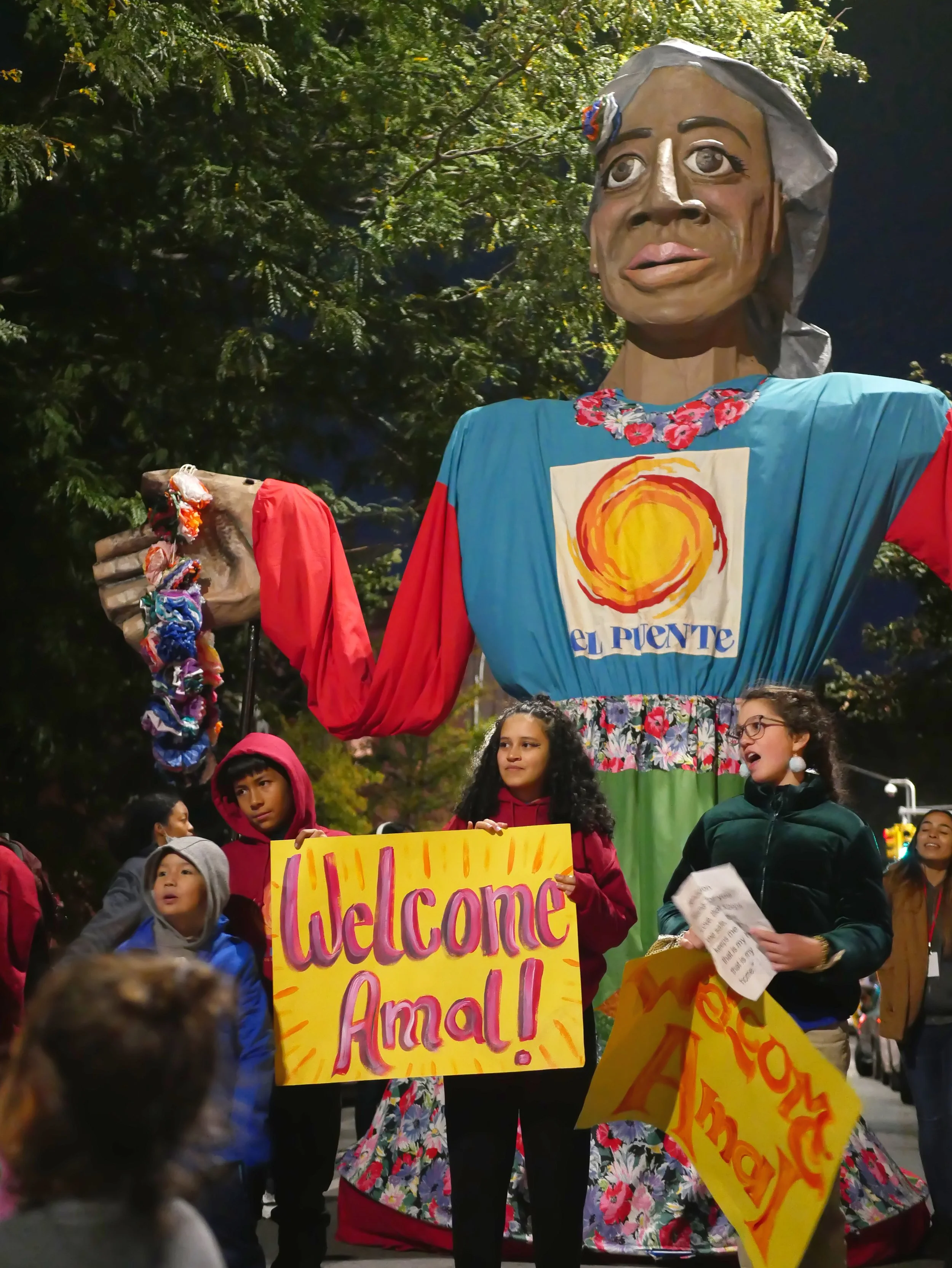 students holding "welcome Amal" sign