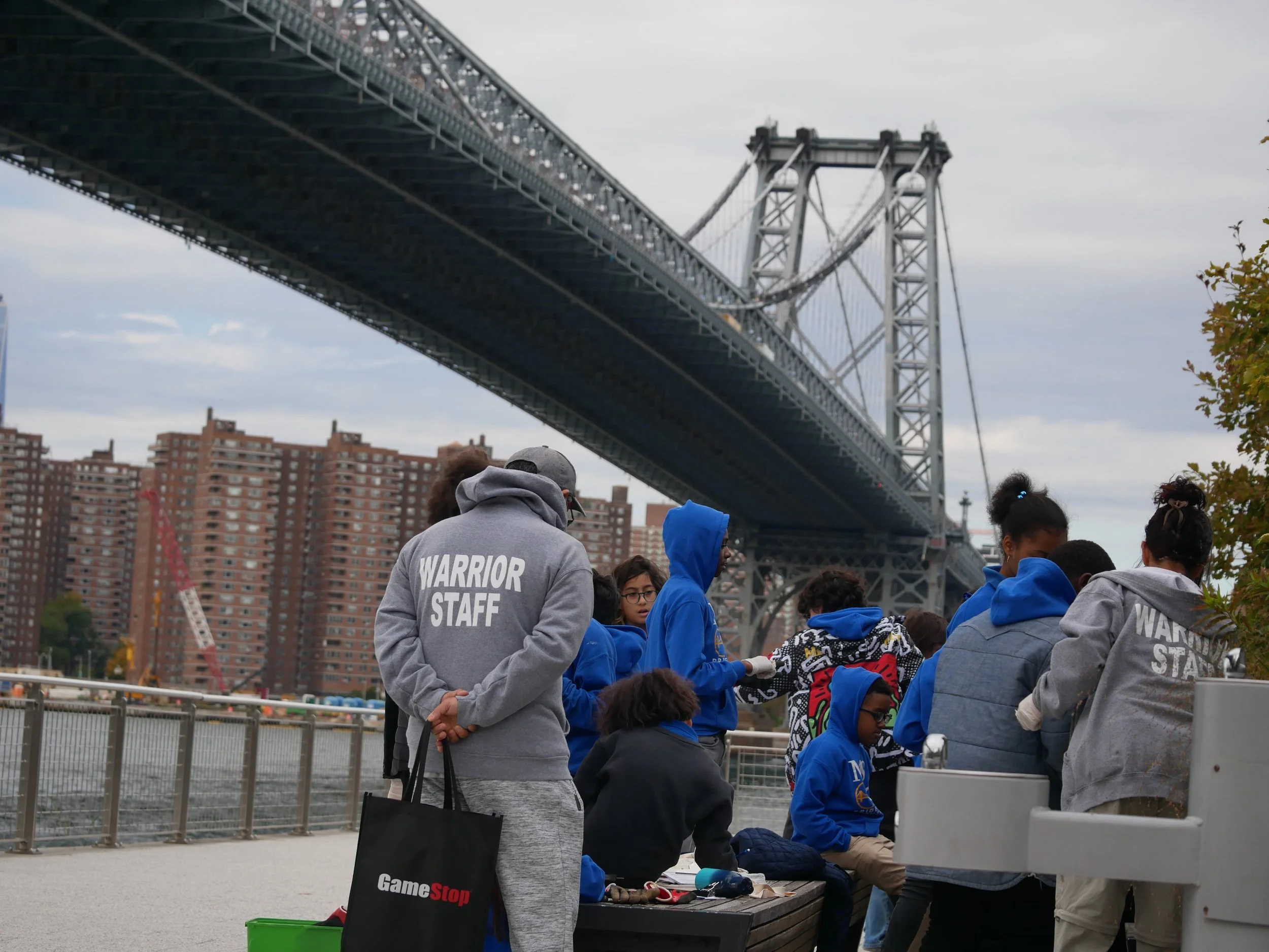 staff gather with williamsburg bridge in background