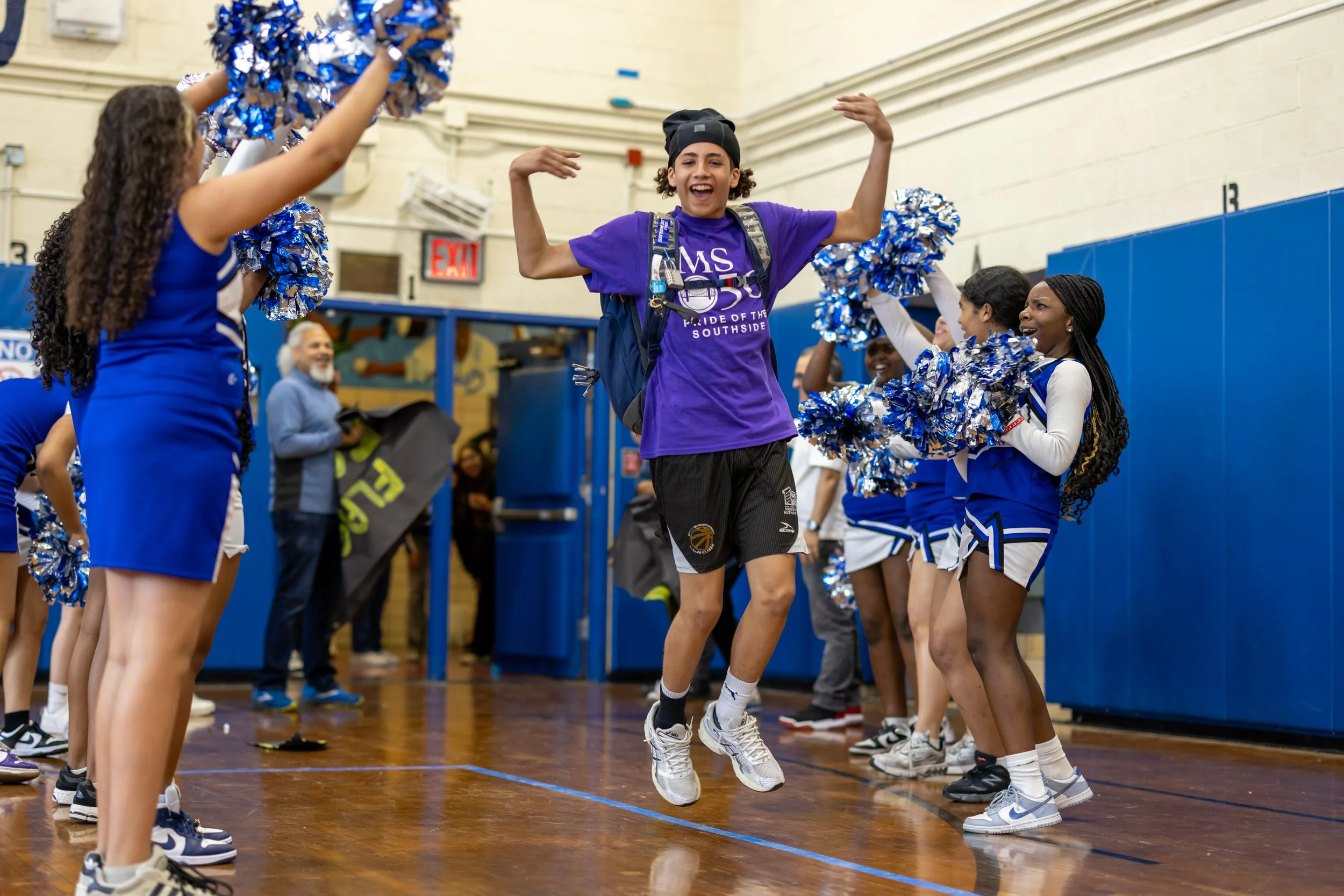 Student runs in through cheerleaders
