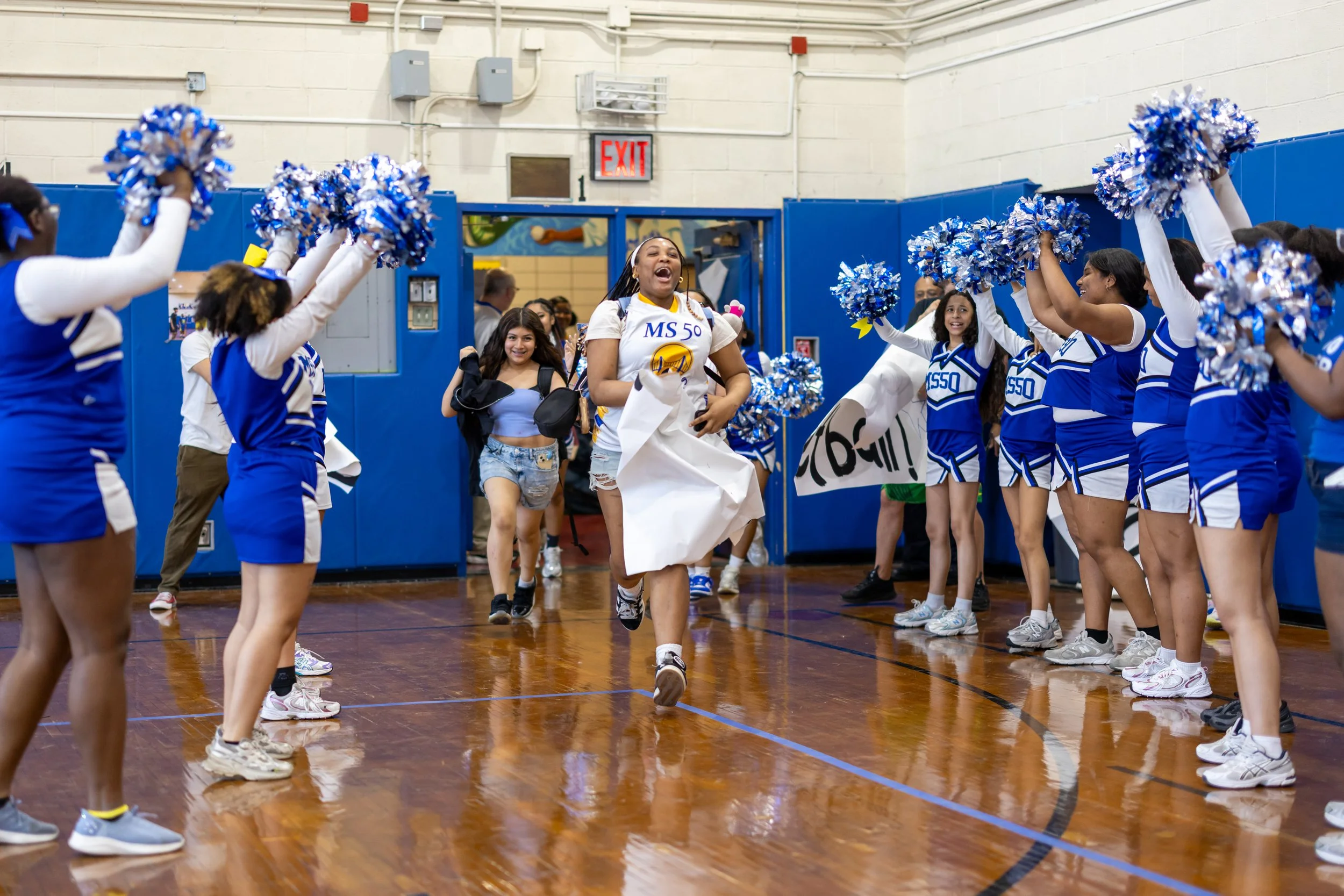 Students run through banners at pep rally