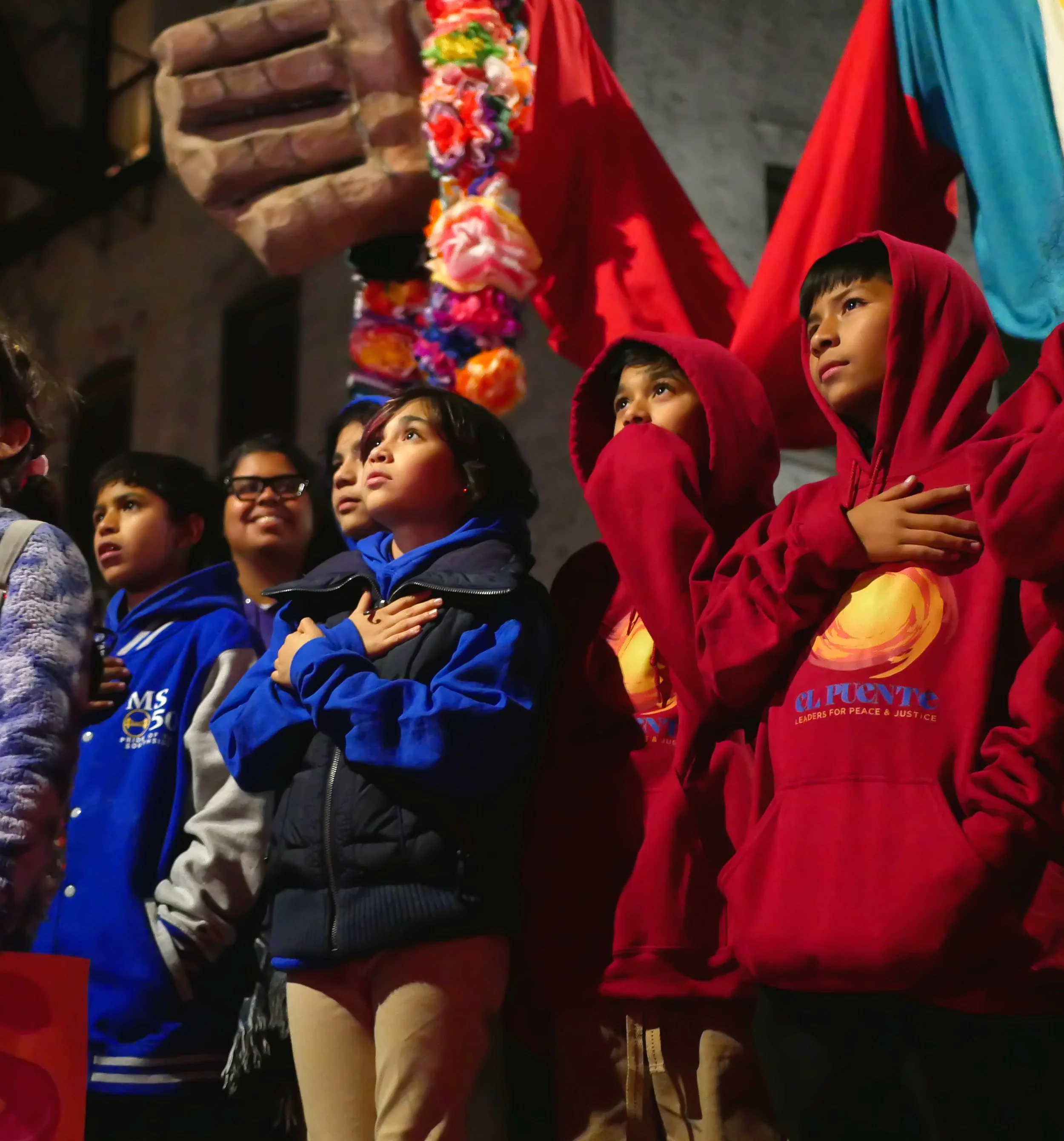 Students look at Amal with hands over their hearts