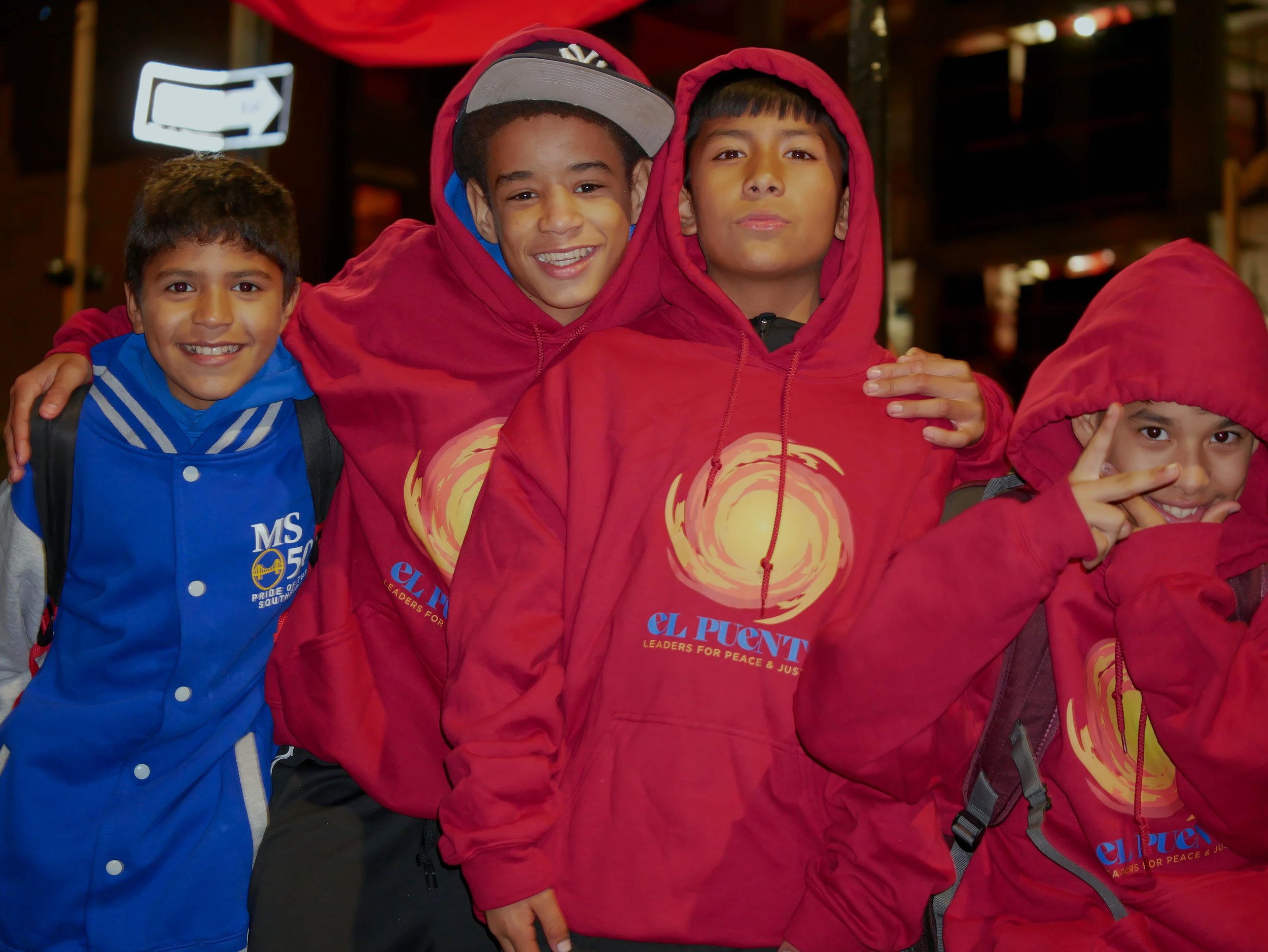 four students pose together