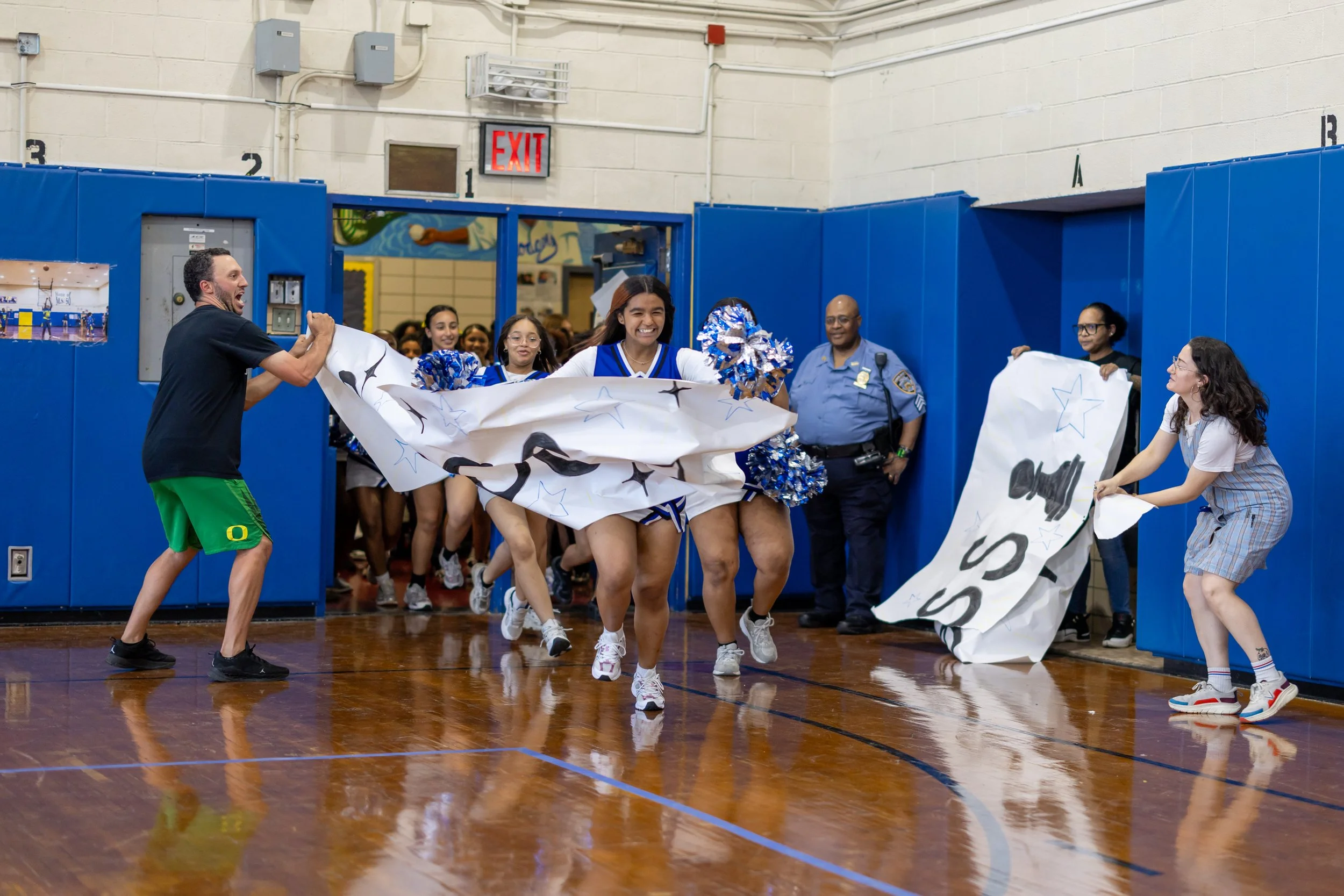 Students run through banners at pep rally