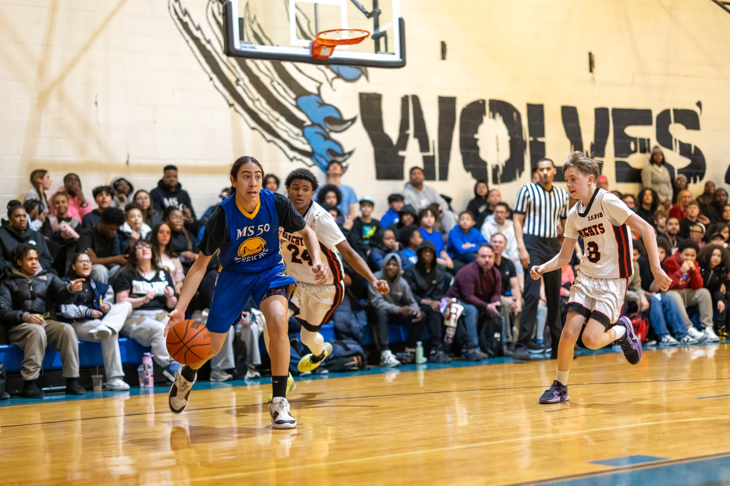 student dribbles at basketball game