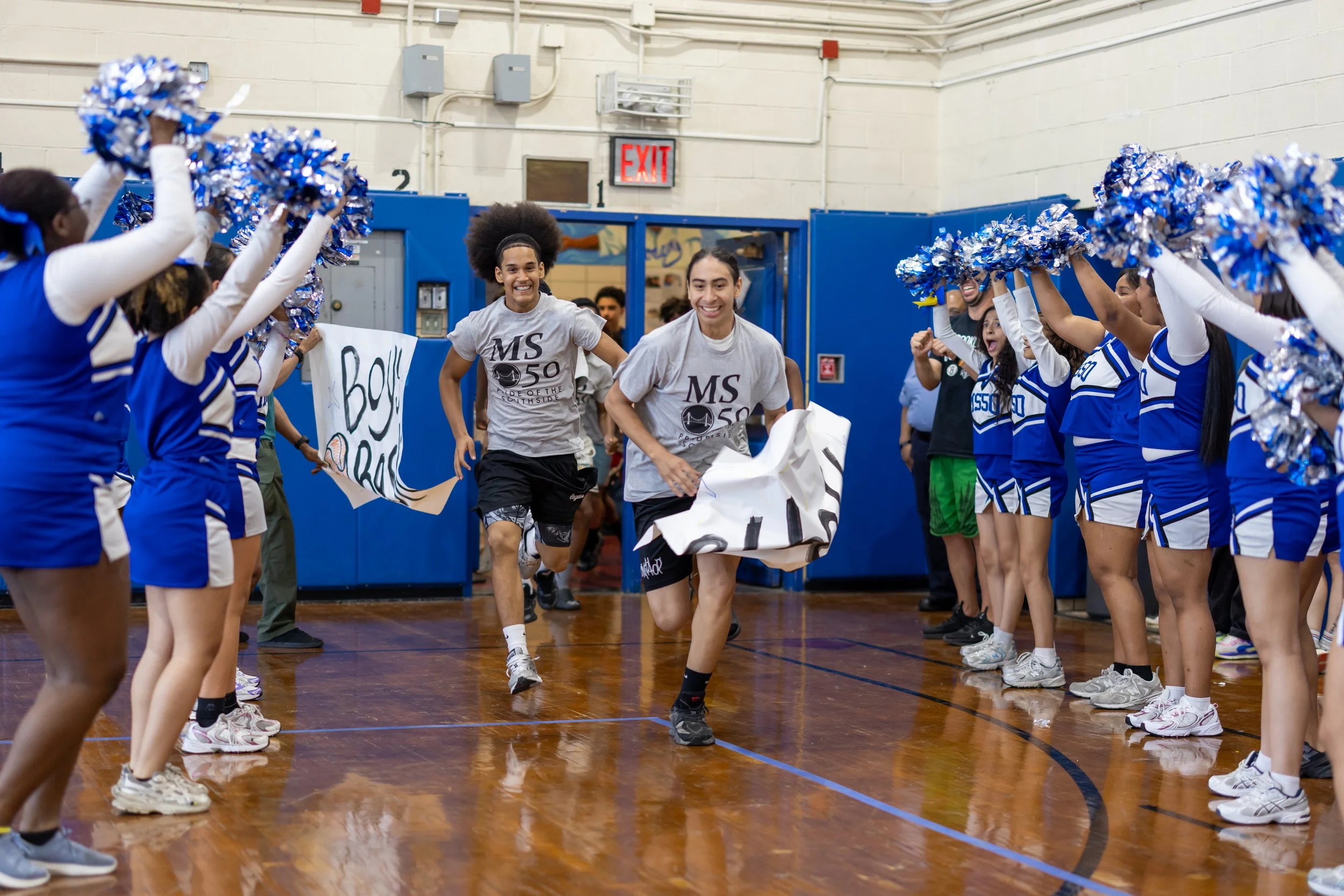 Students run through banners at pep rally