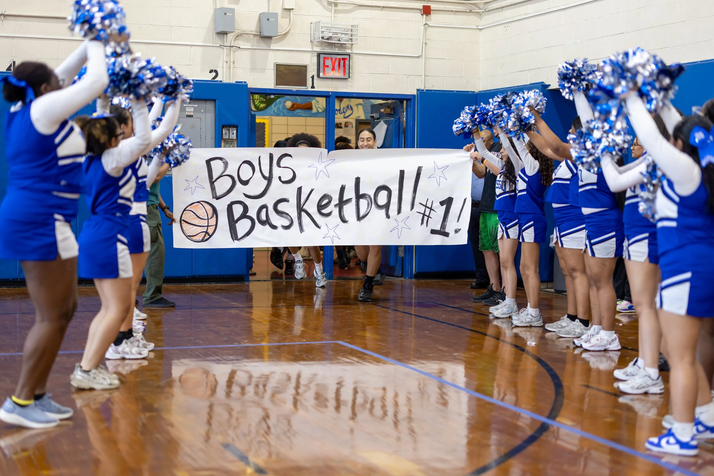 Students run through banners at pep rally
