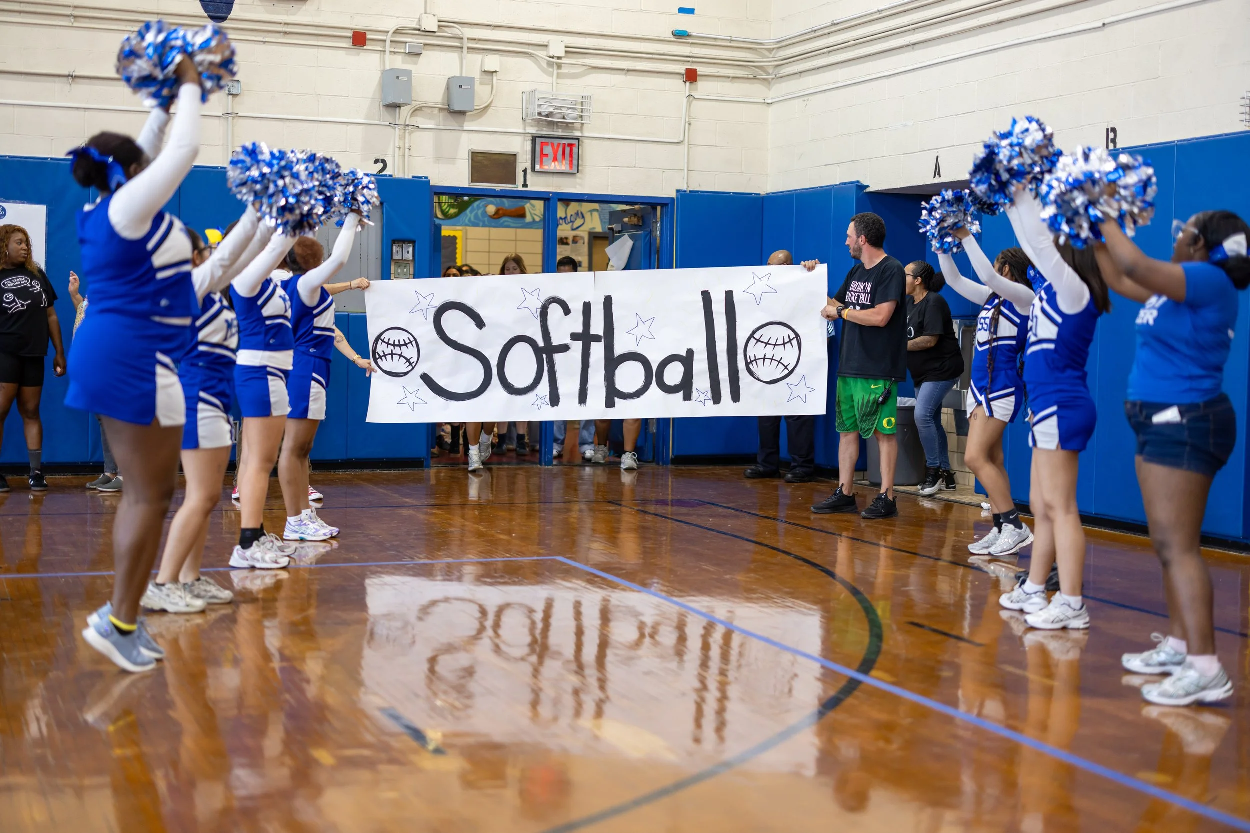 Students run through banners at pep rally