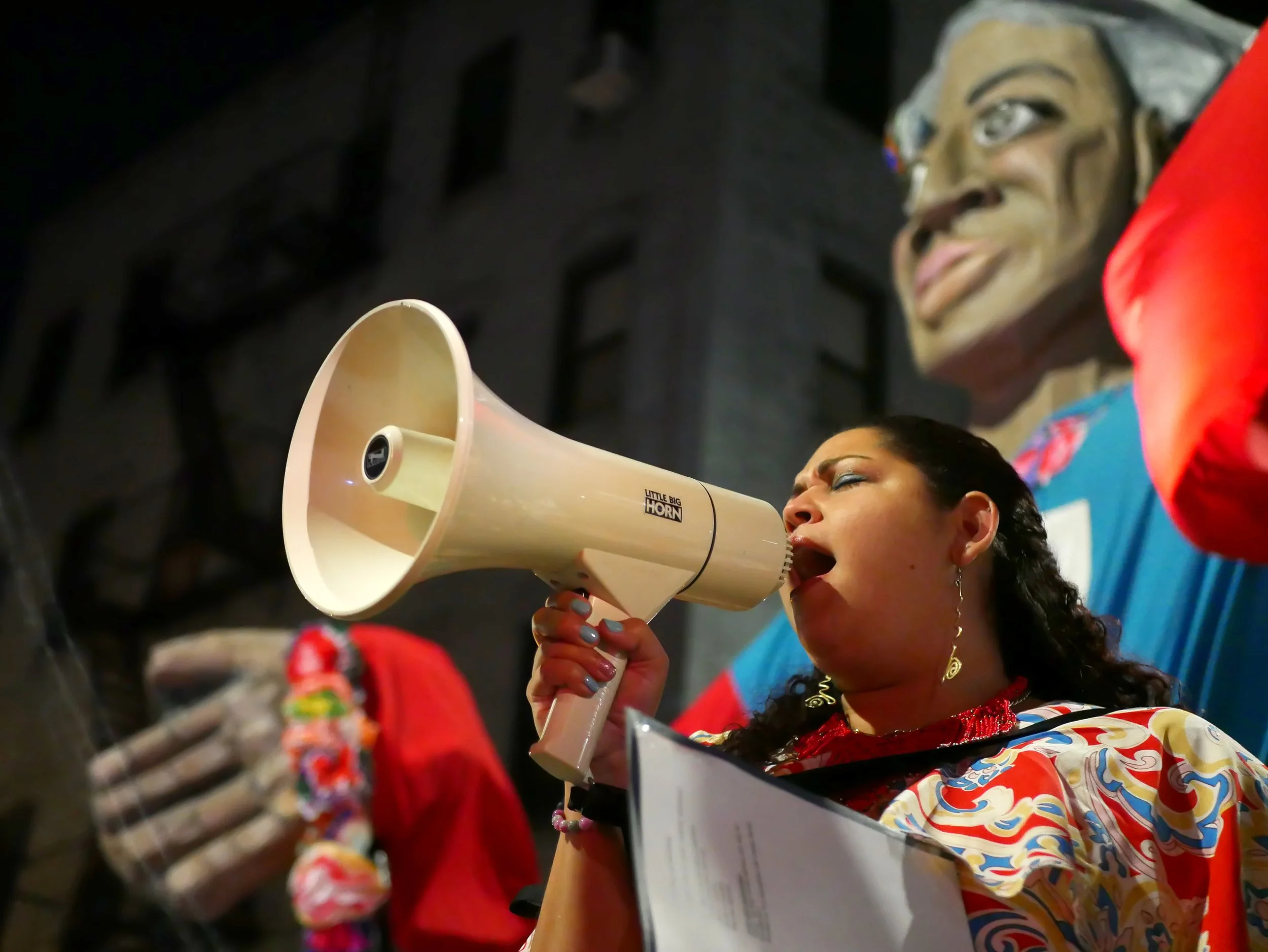 El Puente leader Yasmin speaks into Megaphone
