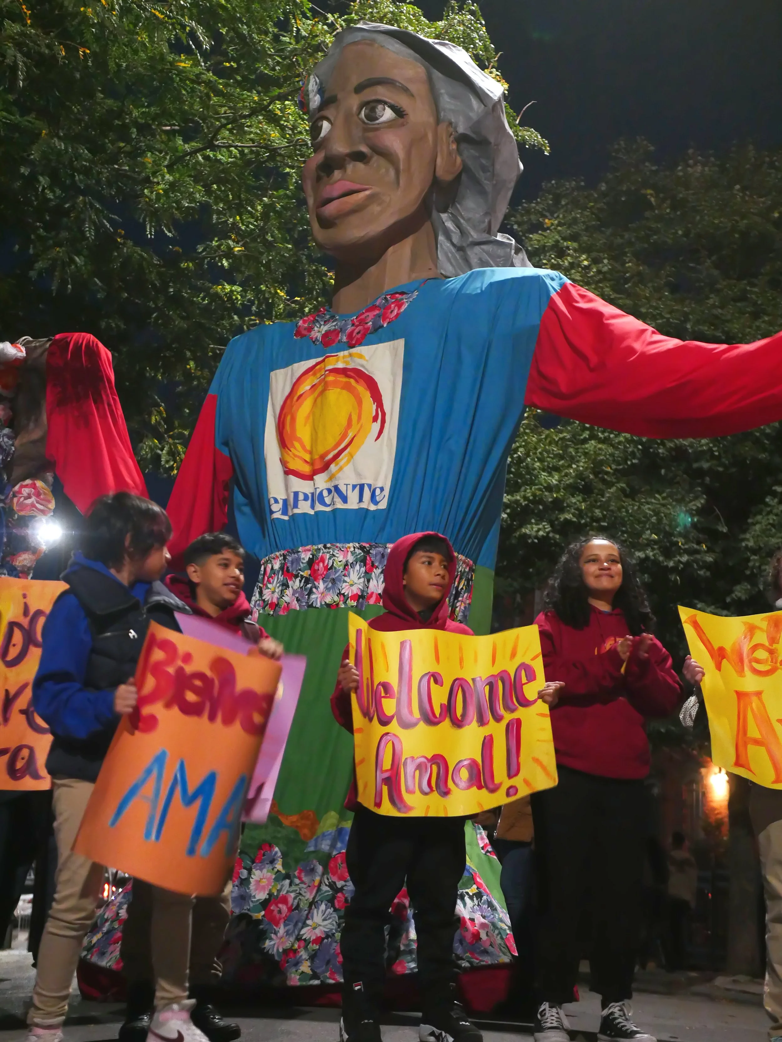 Students hold signs in front of madre tierra 