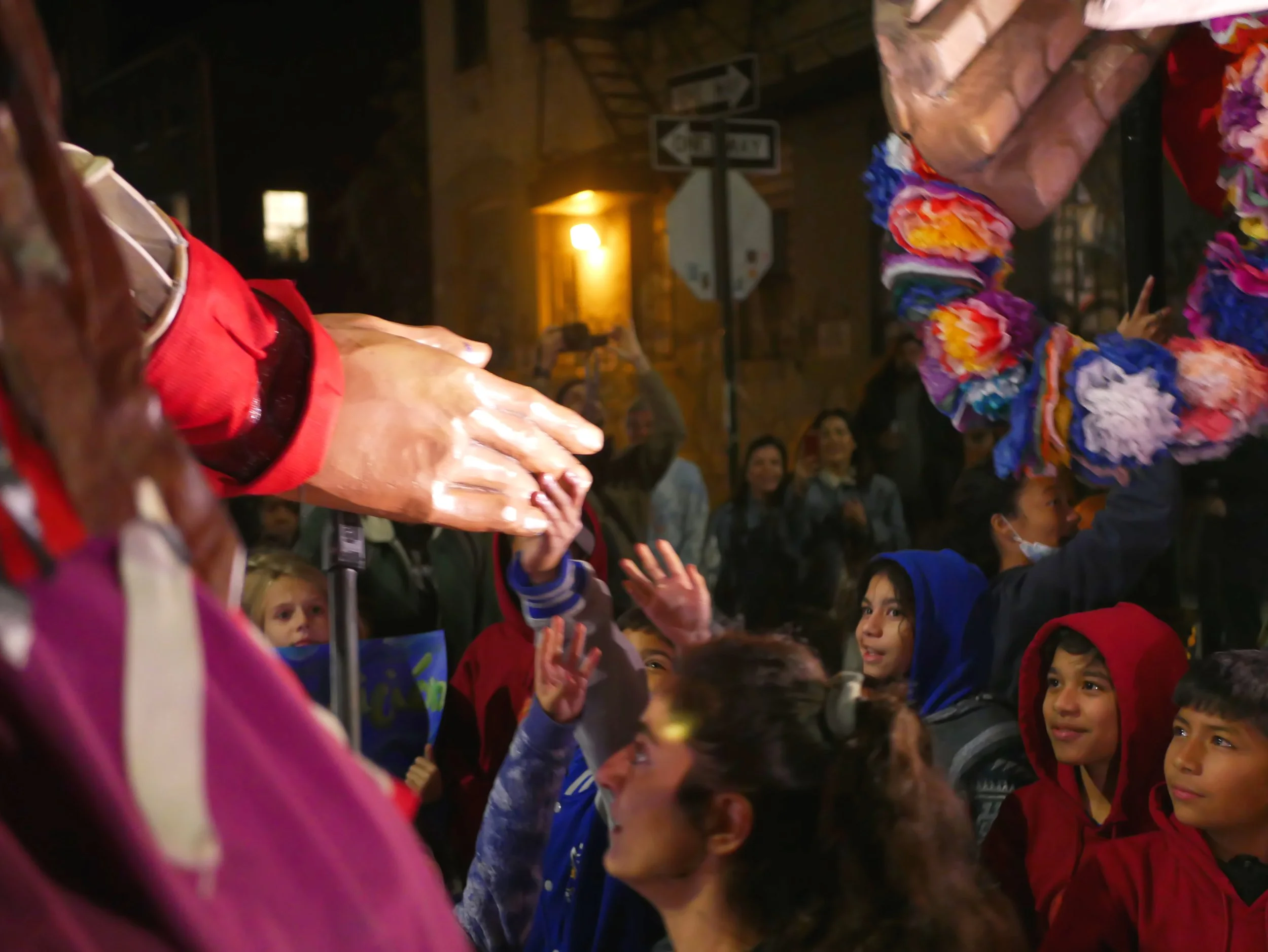 students reach for Amal's hand