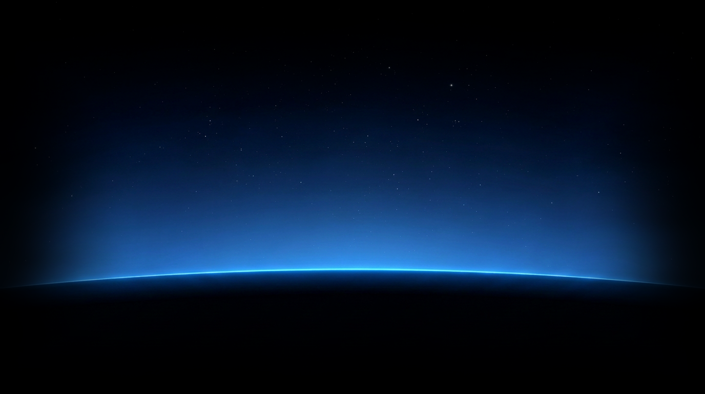View of Earth from space showing a thin blue atmospheric glow at the horizon with a starry night sky above.