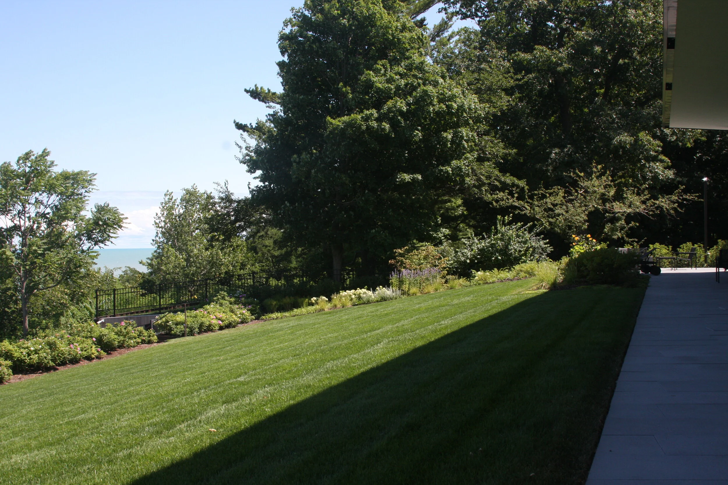 large residential highland park - rear lawn against bluff