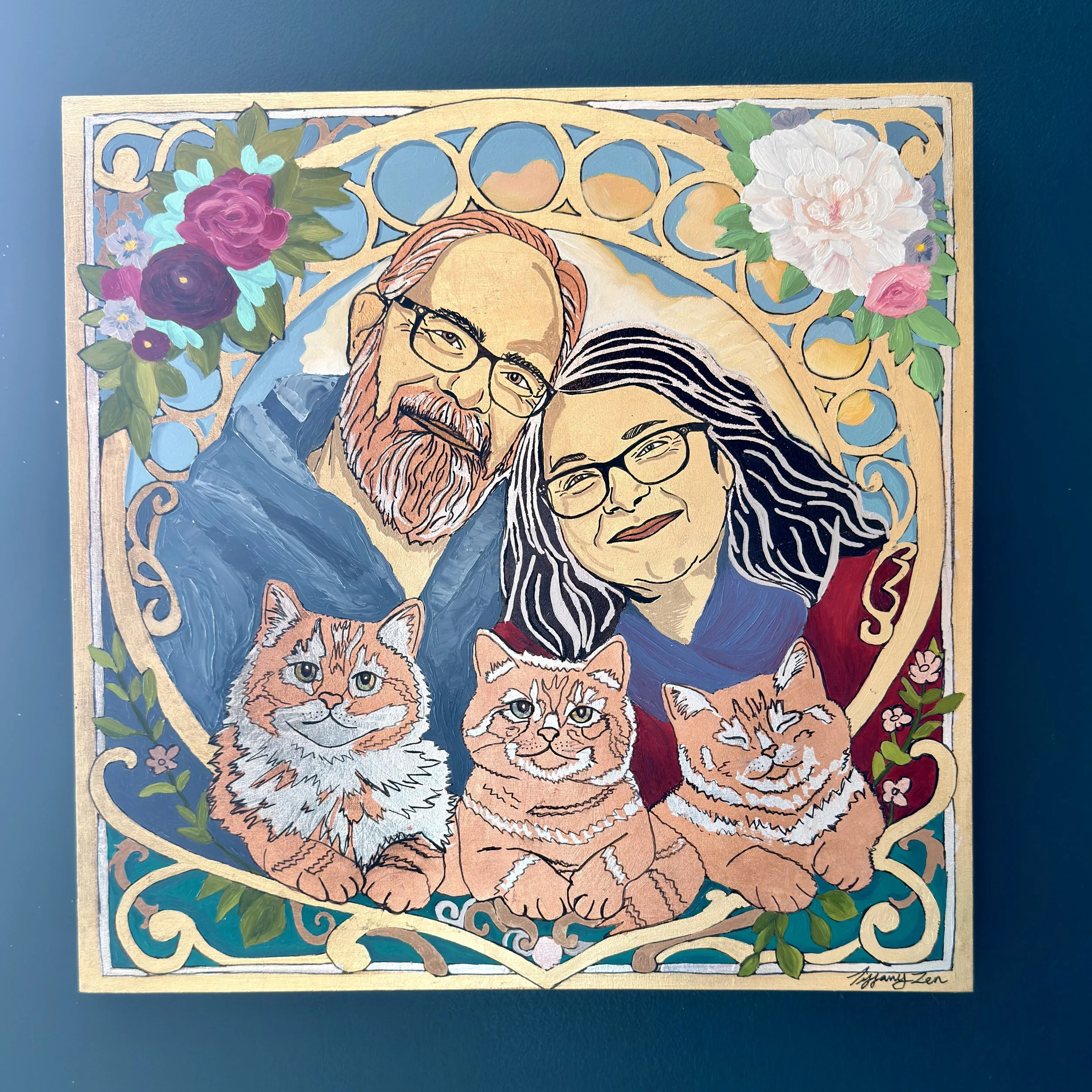 A colorful painting of a man and woman with three cats, surrounded by floral patterns.