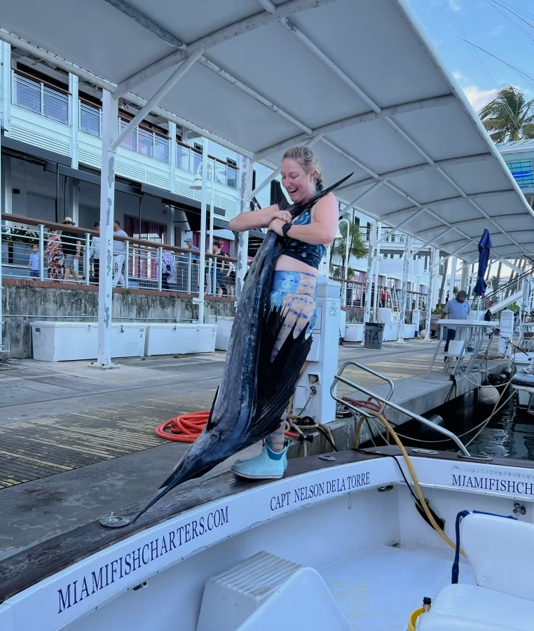 Briana Gibbs, a fisheries scientist, holding a sportfish. 