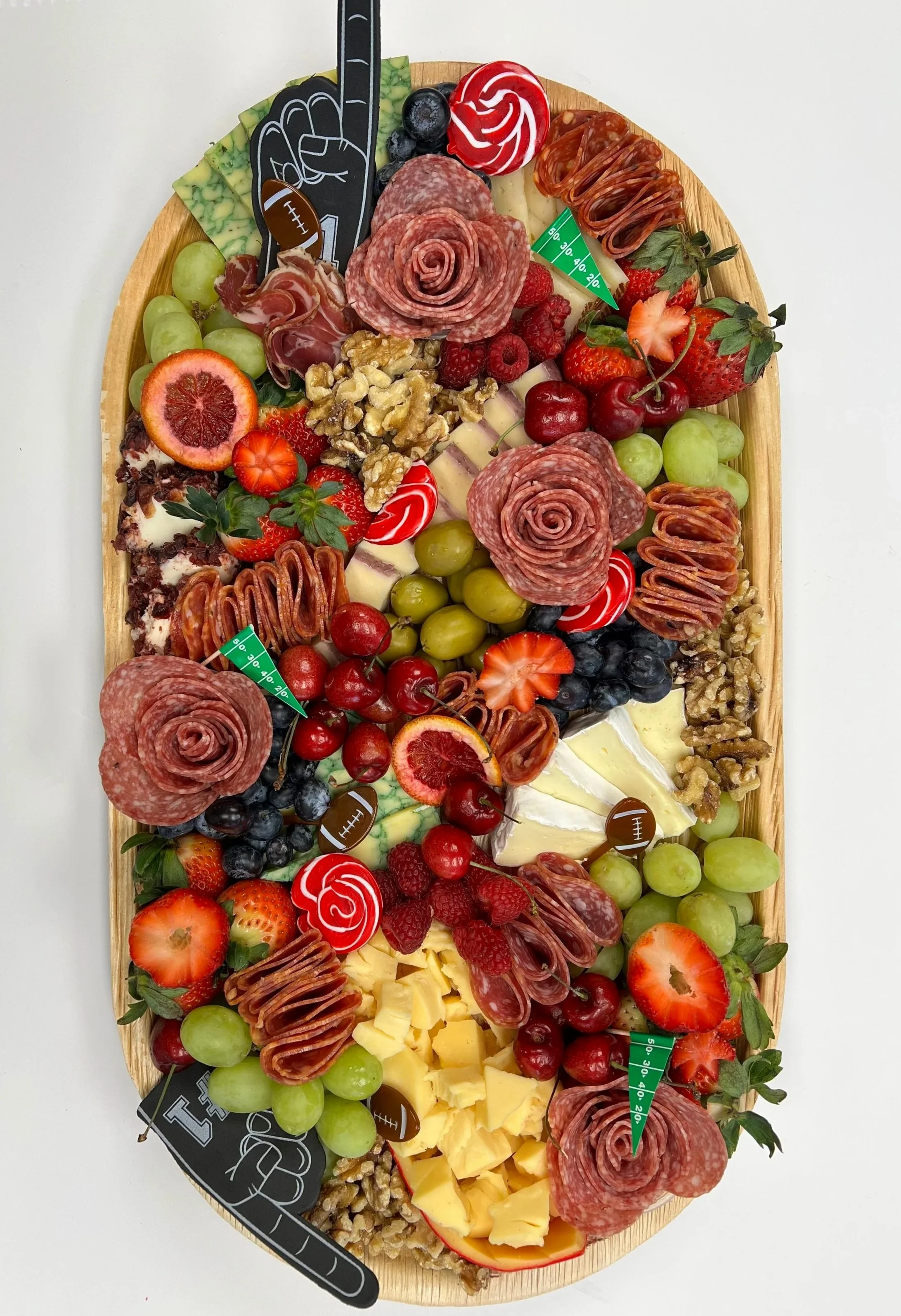 Over-the-top game day charcuterie board loaded with cheeses, meats, fruits, and snack pairings, styled for a Super Bowl party and built for sharing.