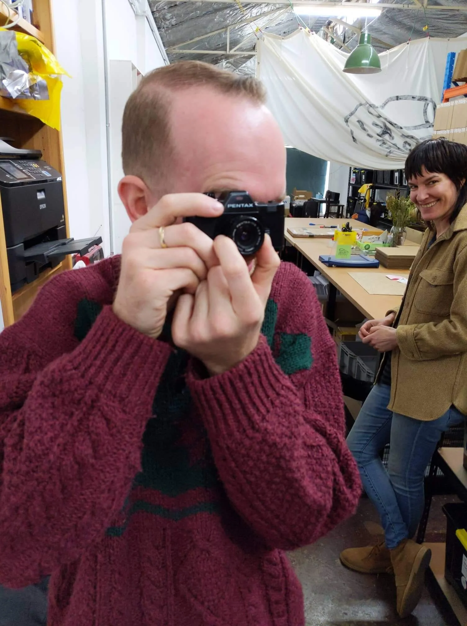 Tristan has a go on a small camera as Jen watches on, unimpressed by his antics.