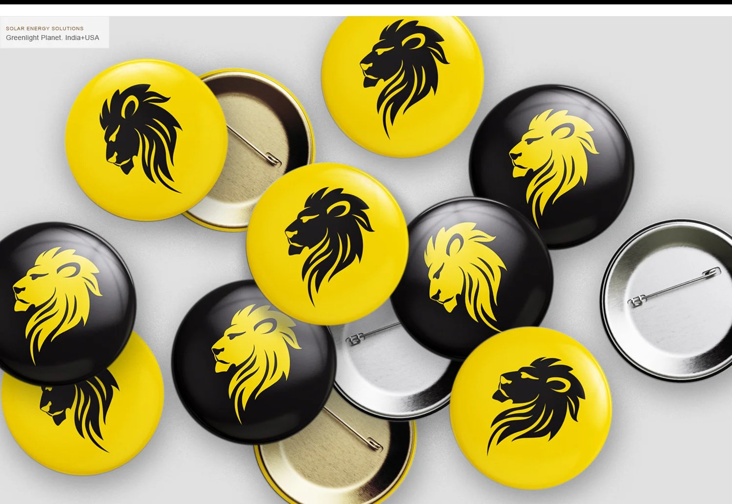Assorted yellow and black buttons with lion logos, some showing the front design and others displaying the back side with pin mechanisms.