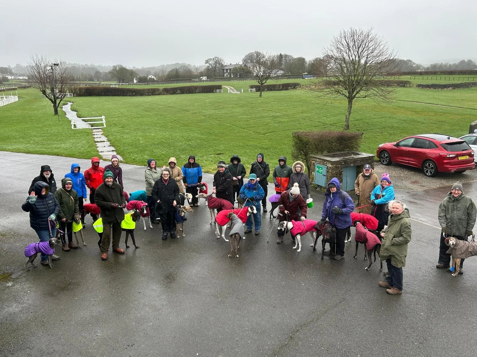 15th March 2026 - 27 hounds and their owners attended the walk at Cartmel Racecourse where they braved the rain and cold winds.  