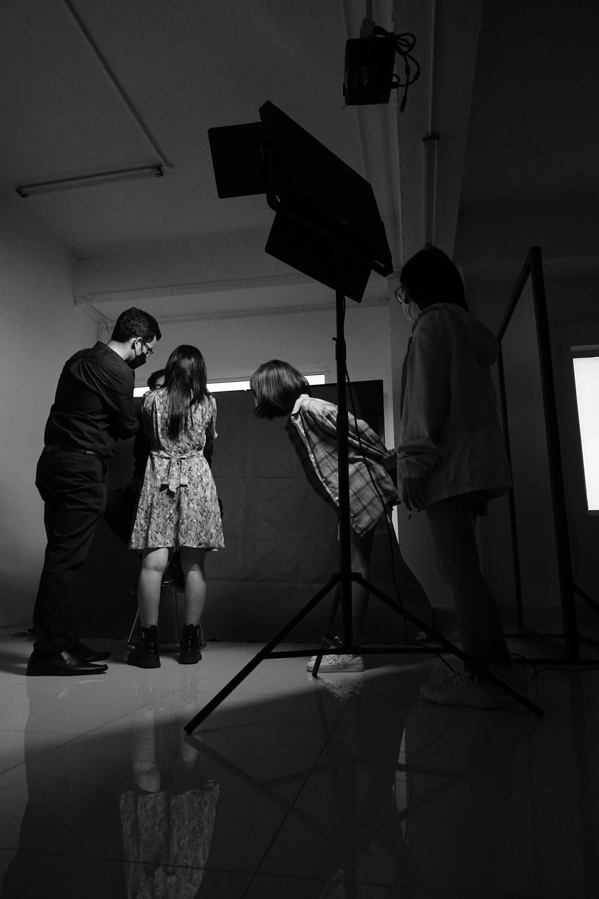 Kids working on a school project in a classroom with a black backdrop and studio lighting.