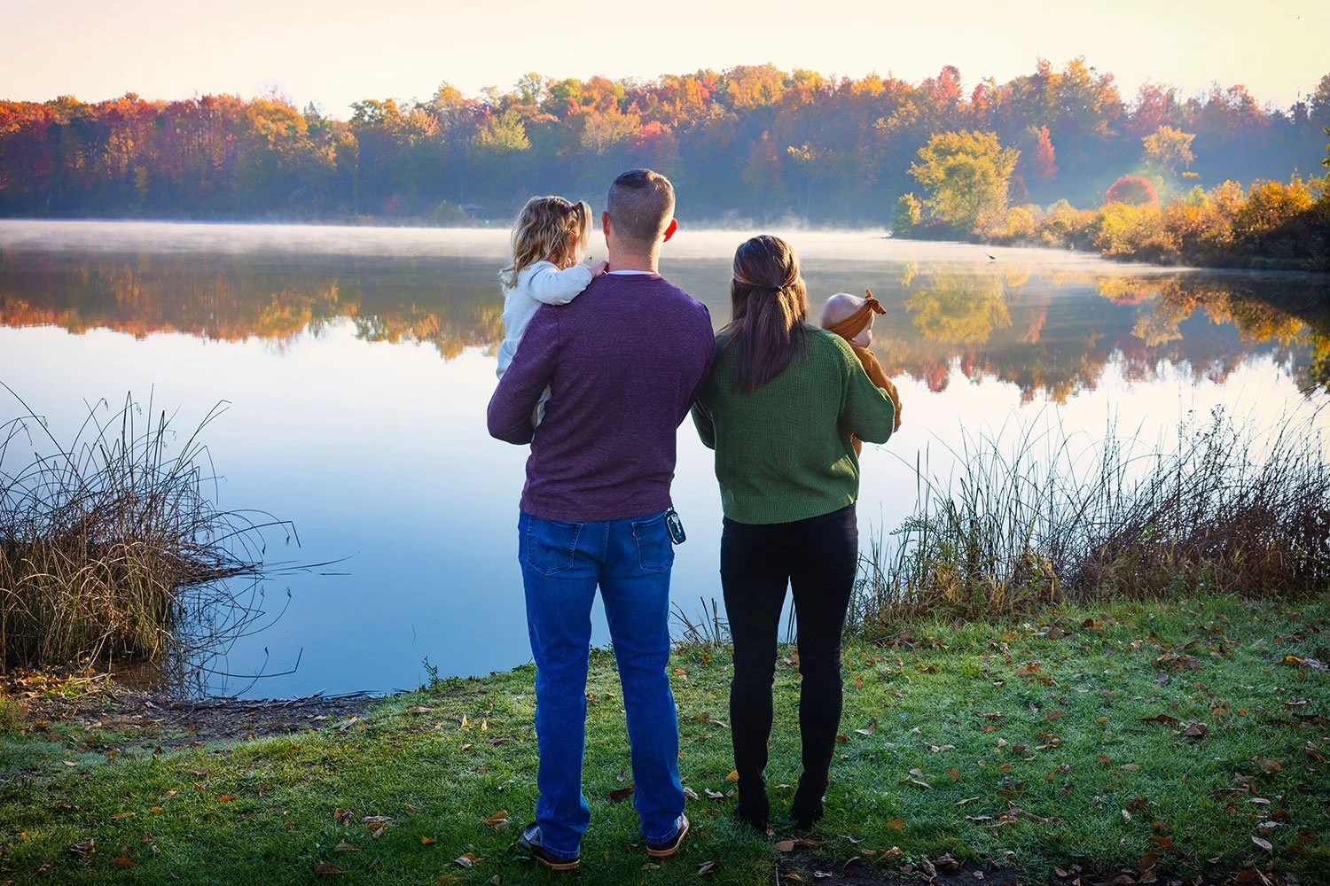 family enjoys the early morning light, fog, and fall leaves at Sunny Lake in Aurora, Ohio