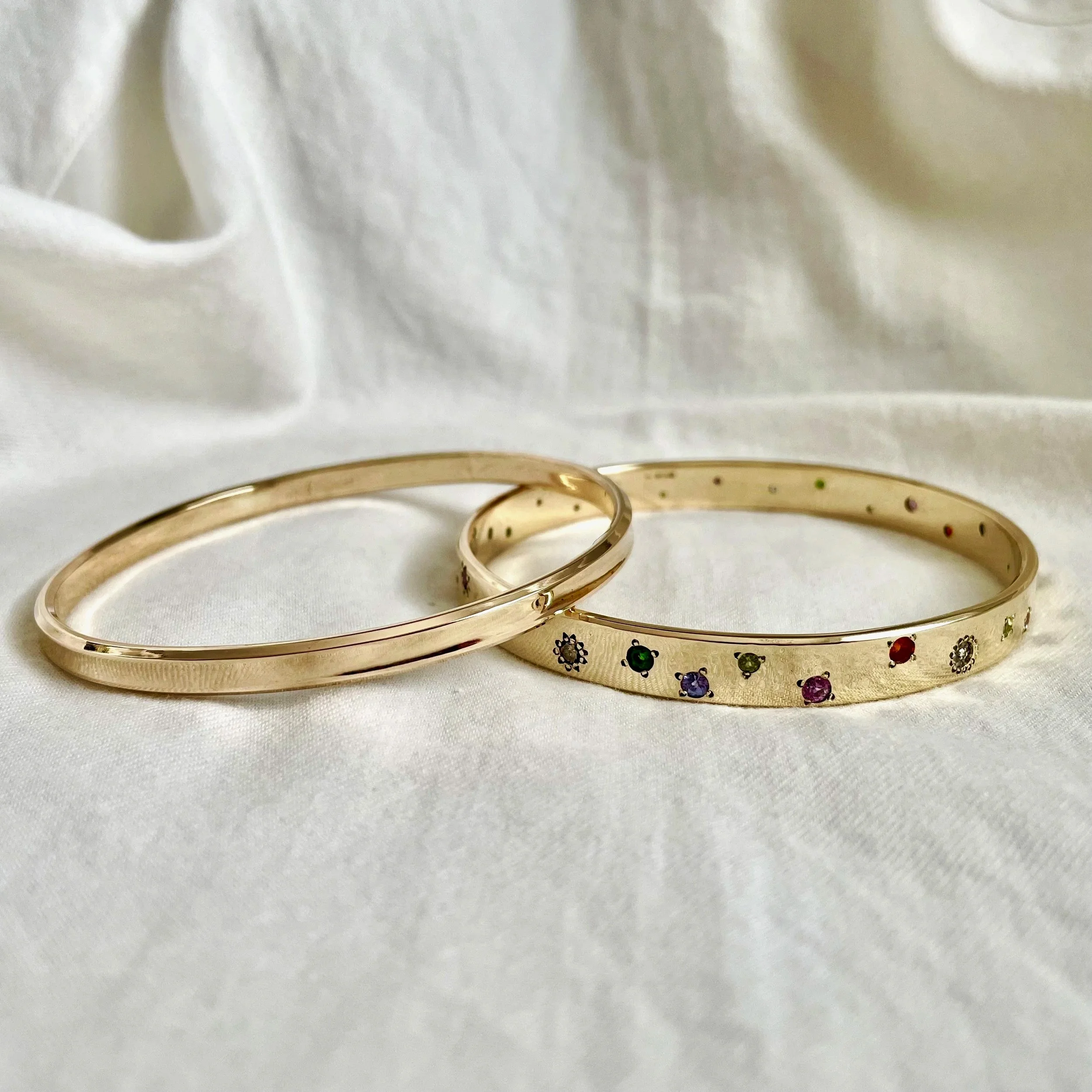 Bangles with flush set stones using customers gold.