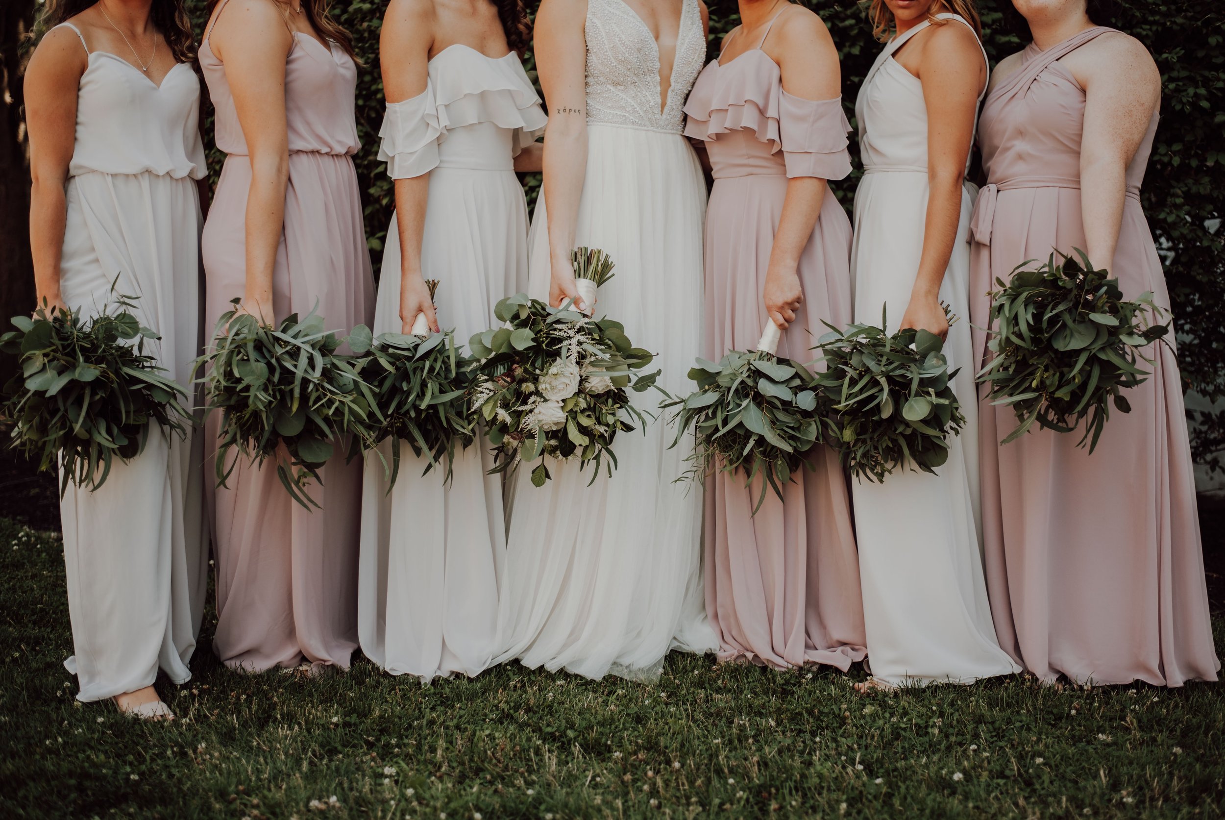 bride and bridesmaids in ivory and light pink dresses
