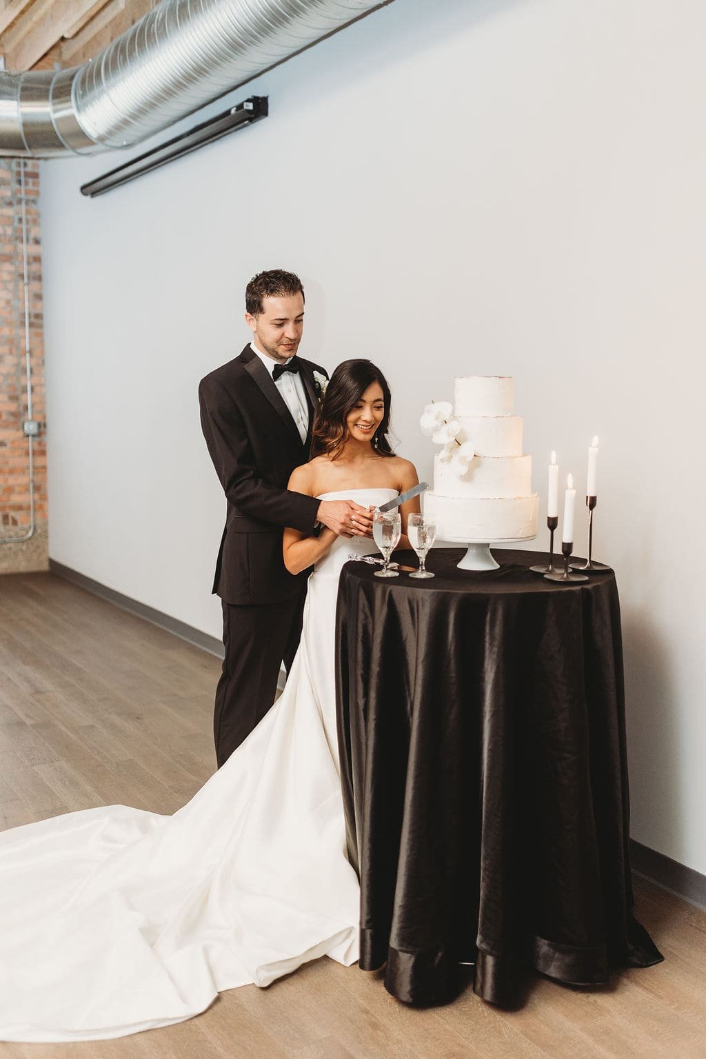 Bride and groom cutting the cake at Outreach Event Space
