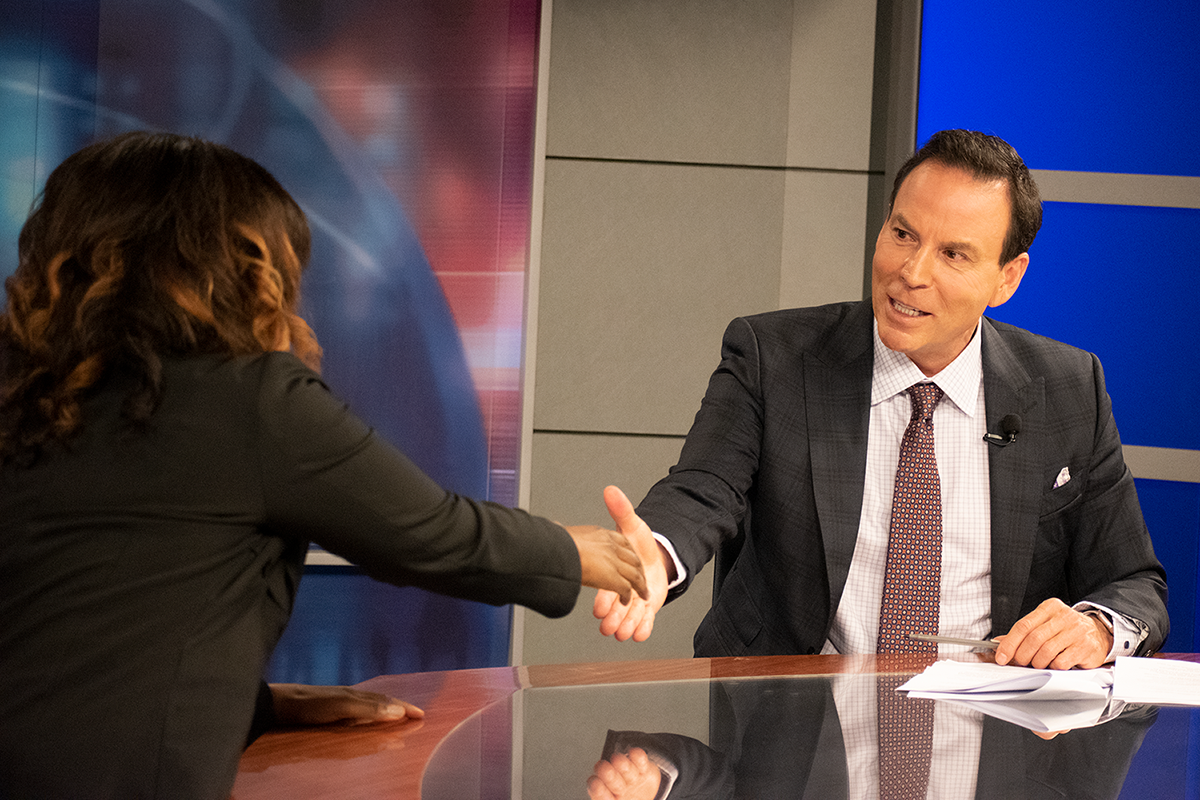Randy Alvarez shaking hands with Dr. Roberts after her Wellness Hour Newsroom interview