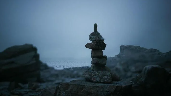 rock-stack-balanced-on-a-beach-during-foggy-twilight-hours-near-the-ocean-video.jpg