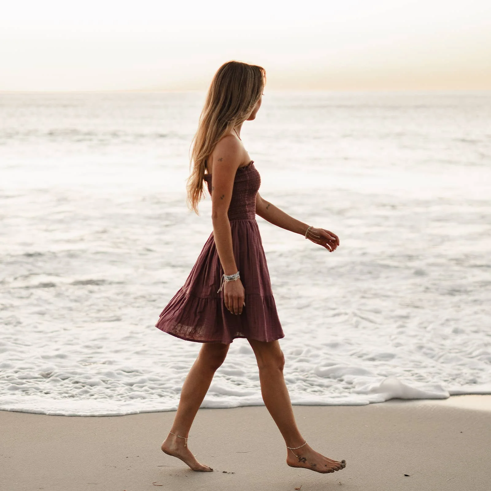 Lotus and Luna Berry Daiquiri Dress made from 100% organic cotton has a smocked bodice and tiered hem.