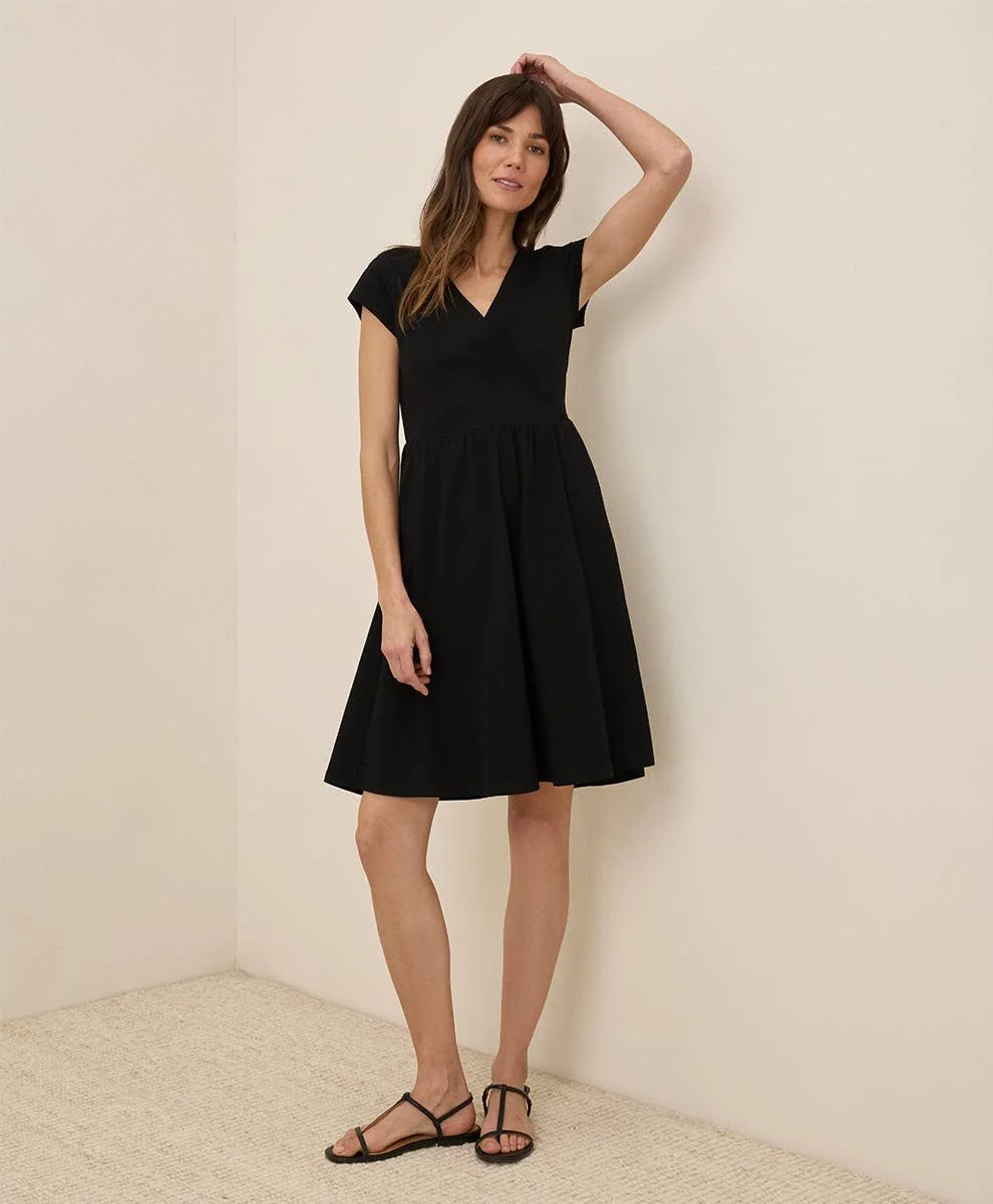 Pact 100% GOTs Cotton Fit & Flare Crossover Dress with short sleeves in the color black