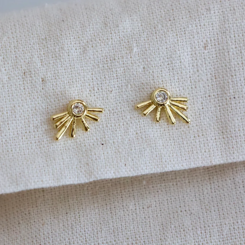 Mesa Blue Gold Starburst Stud Earrings with a cubic zirconia stone in the center.