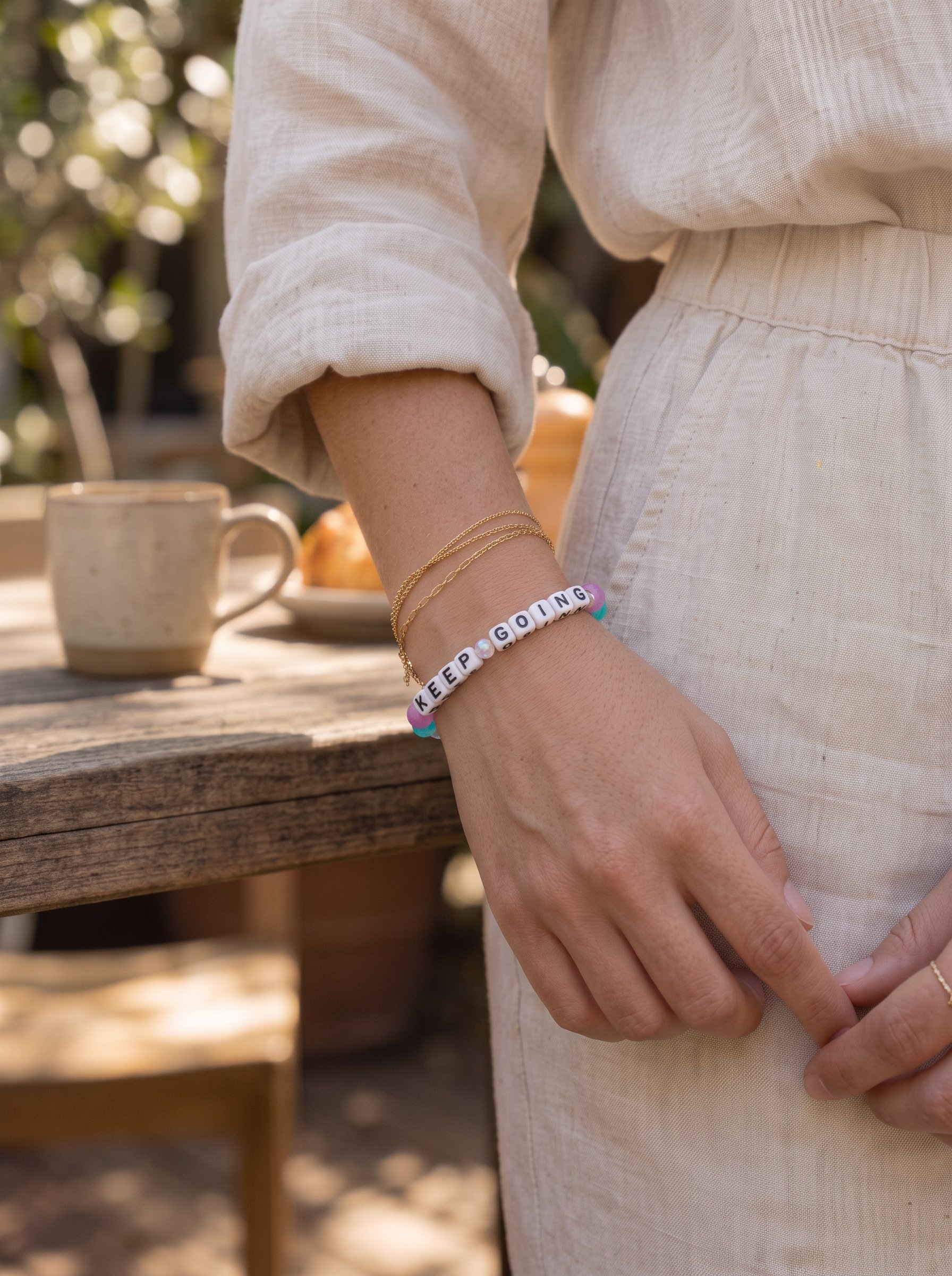 Little Words Project bracelet with the words "Keep Going" in the soft layers colorway