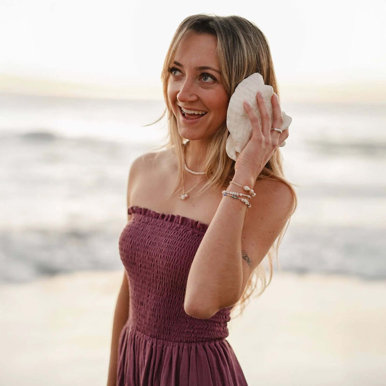 Lotus and Luna Berry Daiquiri Dress made from 100% organic cotton has a smocked bodice and tiered hem.