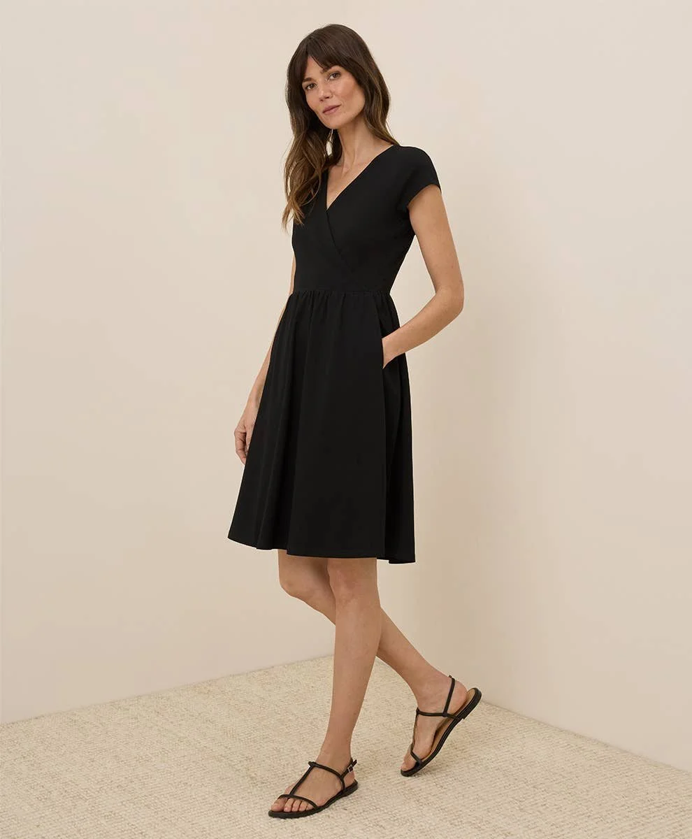 Pact 100% GOTs Cotton Fit & Flare Crossover Dress with short sleeves in the color black