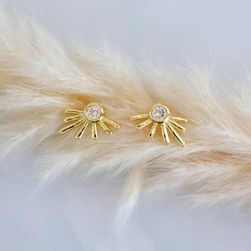 Mesa Blue Gold Starburst Stud Earrings with a cubic zirconia stone in the center.